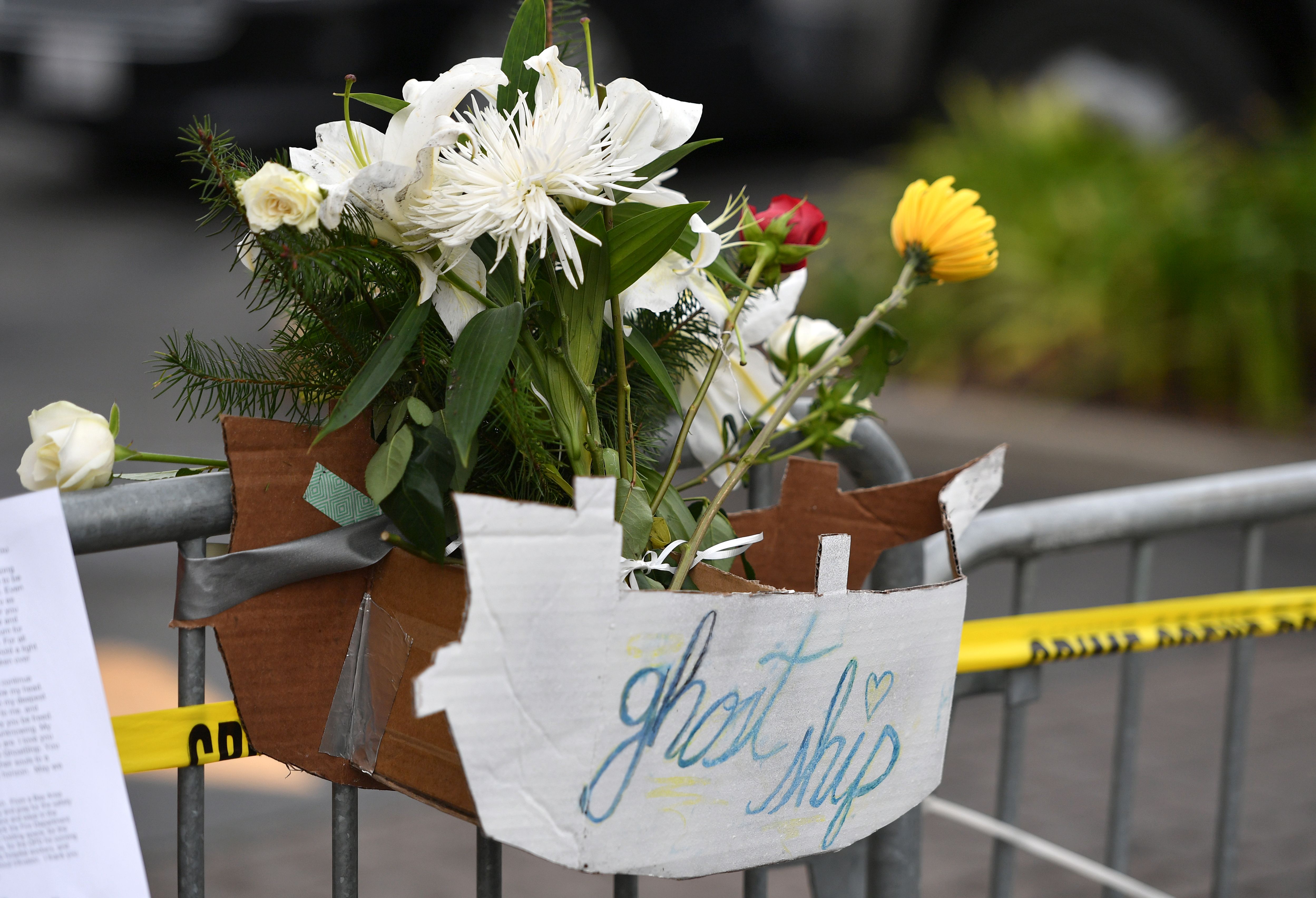 Flowers are seen at a makeshift memorial near the site of a fire-ravaged warehouse where at least 36 people died in Oakland, Dec. 5, 2016. (Credit: JOSH EDELSON/AFP/Getty Images)