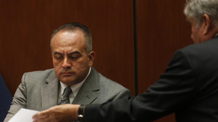 California Assembly member Raul Bocanegra, left, is shown a document by defense attorney Richard P. Lasting, right, during the perjury and voter fraud trial of Richard Alarcon in this undated photo. (Credit: Anne Cusack/Los Angeles Times)