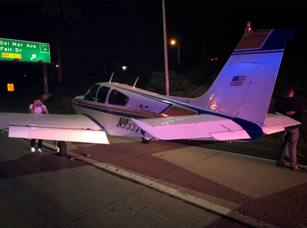 The pilot of a beachcraft bonanza that landed on the 55 Freeway in Costa Mesa talks on a cellphone on Jan. 28, 2018. (Credit: Costa Mesa Fire Department)