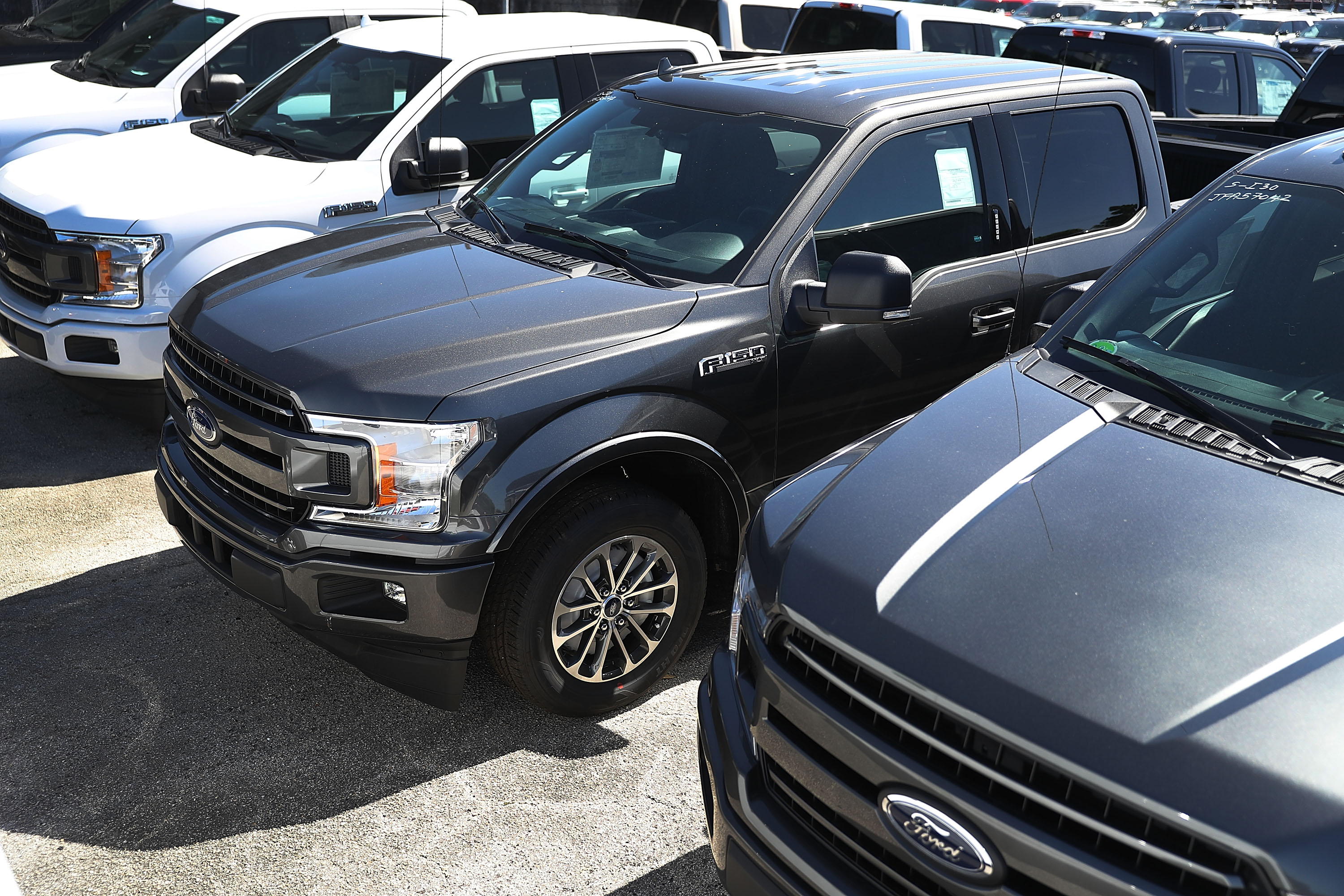 Ford F-150 pickup trucks are seen on a Miami, Florida, sales lot on Oct. 26, 2017. (Credit: Joe Raedle / Getty Images)