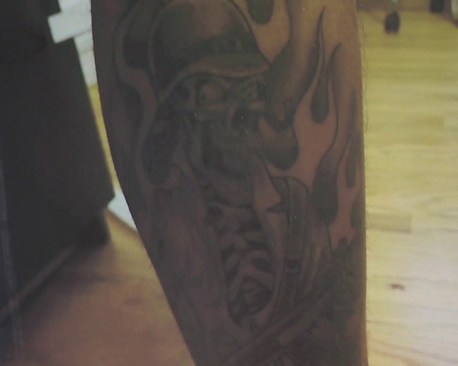 A tattoo worn by L.A. County Sheriff's Deputy Samuel Aldama is seen in a photo displayed during a press conference held by the Sweeney Firm on July 14, 2018. (Credit: KTLA)