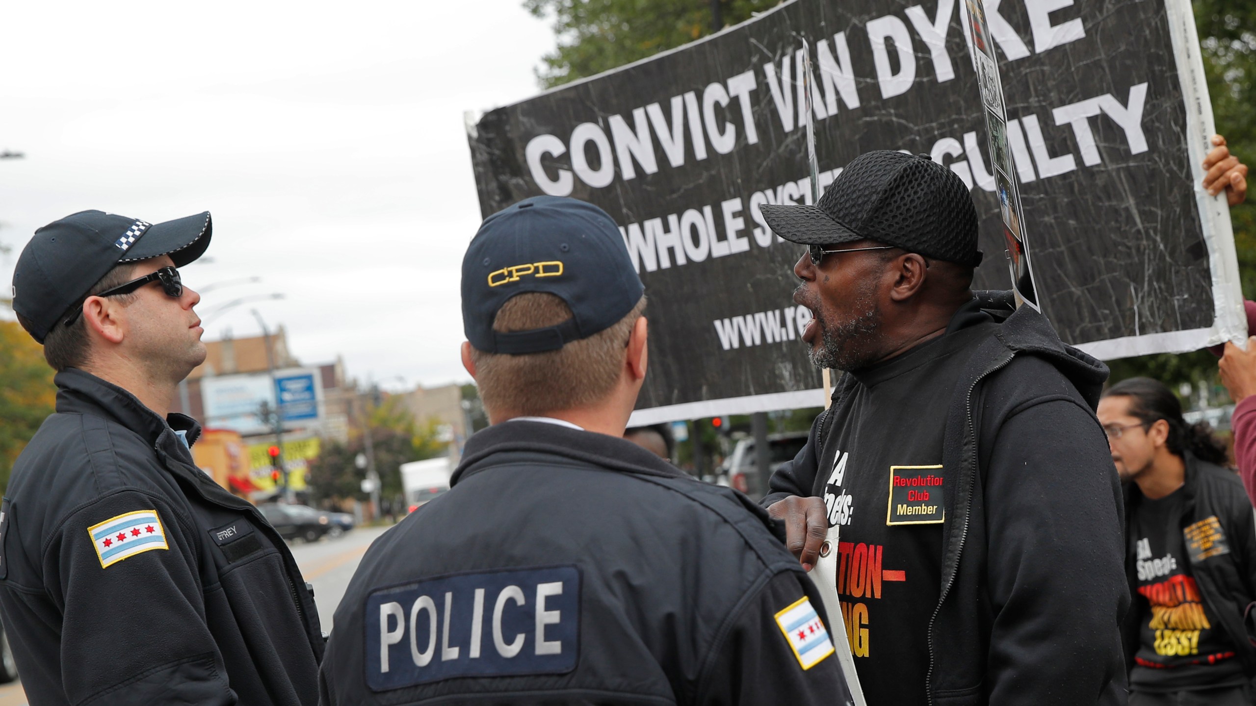 Protesters calling for the conviction of Chicago police officer Jason Van Dyke demonstrate in front of a line of Chicago police officers outside the Leighton Criminal Court Building in Chicago, October 4, 2018. (Credit: JIM YOUNG/AFP/Getty Images)