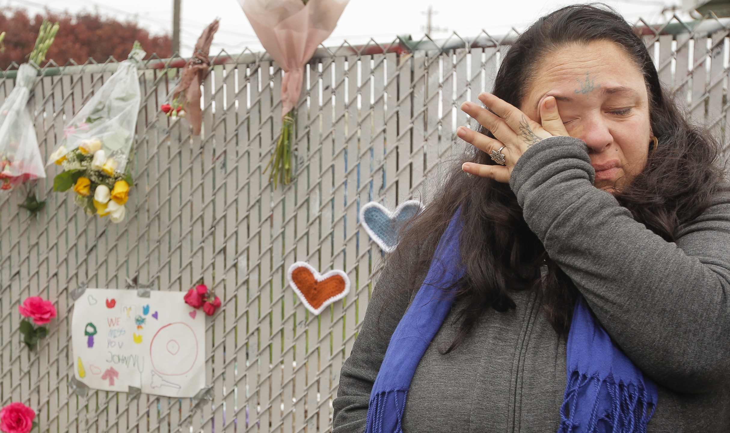 Danielle Boudreaux, who knew the man who rented out the Ghost Ship warehouse for parties and was a frequent visitor herself, cries by a makeshift memorial near the site of a warehouse fire that has claimed the lives of at least 36 people on Dec. 5, 2016, in Oakland. (Credit: Elijah Nouvelage/Getty Images)