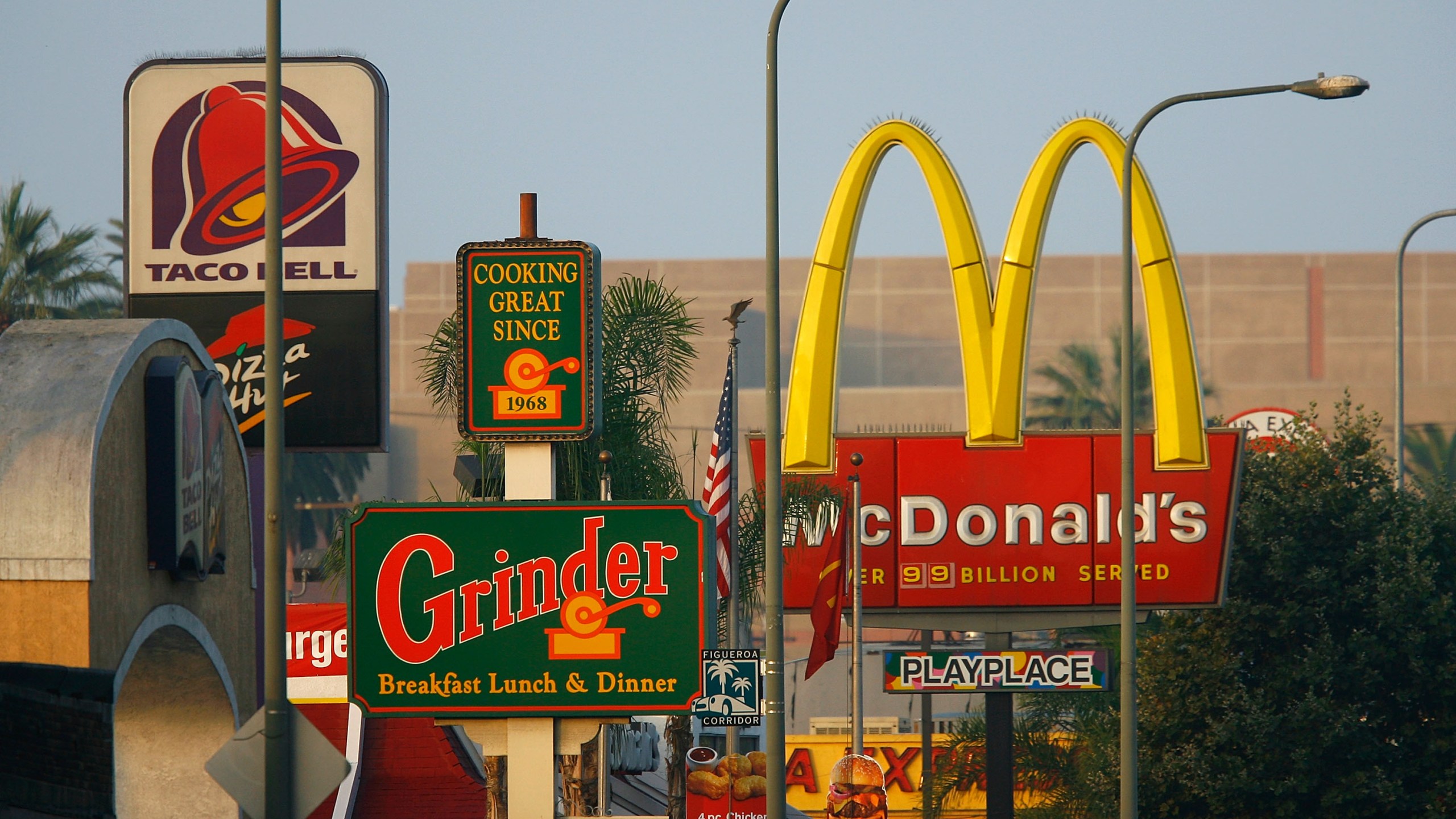 Signs for Taco Bell, Grinder, McDonald's and Panda Express fast-food restaurants line the streets in the Figueroa Corridor area of South Los Angeles on July 24, 2008. (Credit: David McNew / Getty Images)