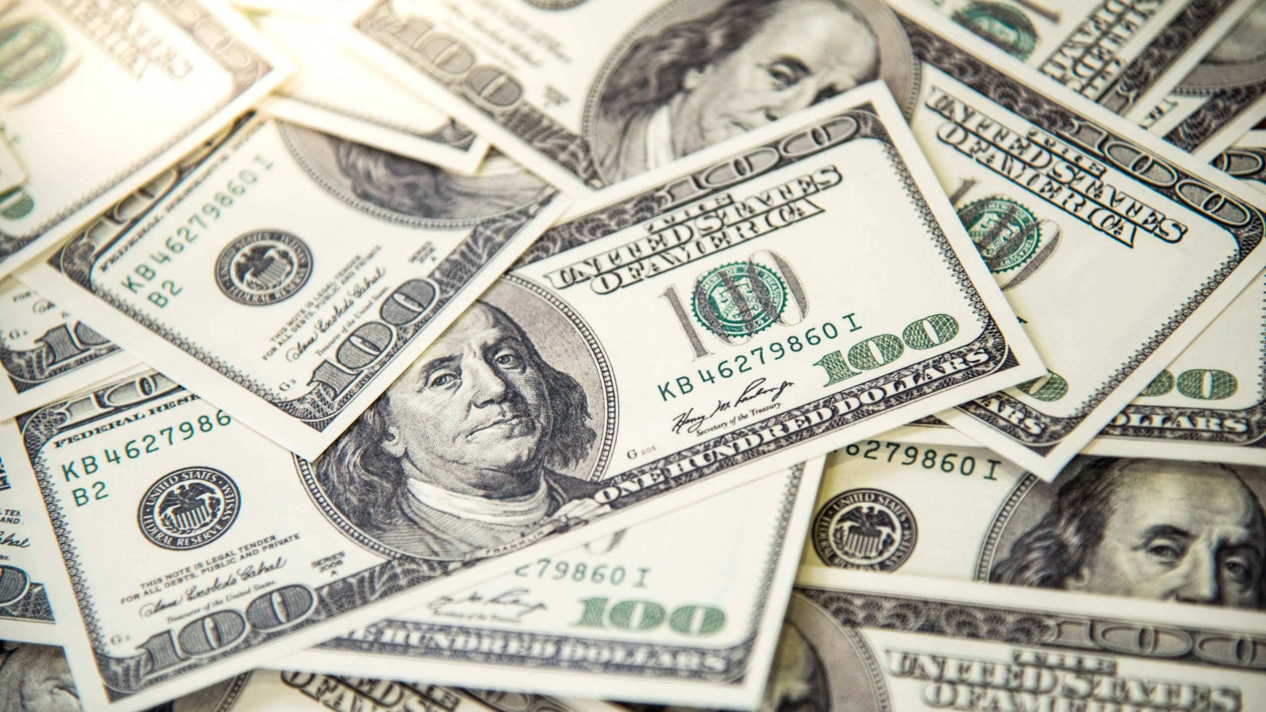 A pile of $100 bills is seen in a file photo. (Credit: iStock / Getty Images Plus)