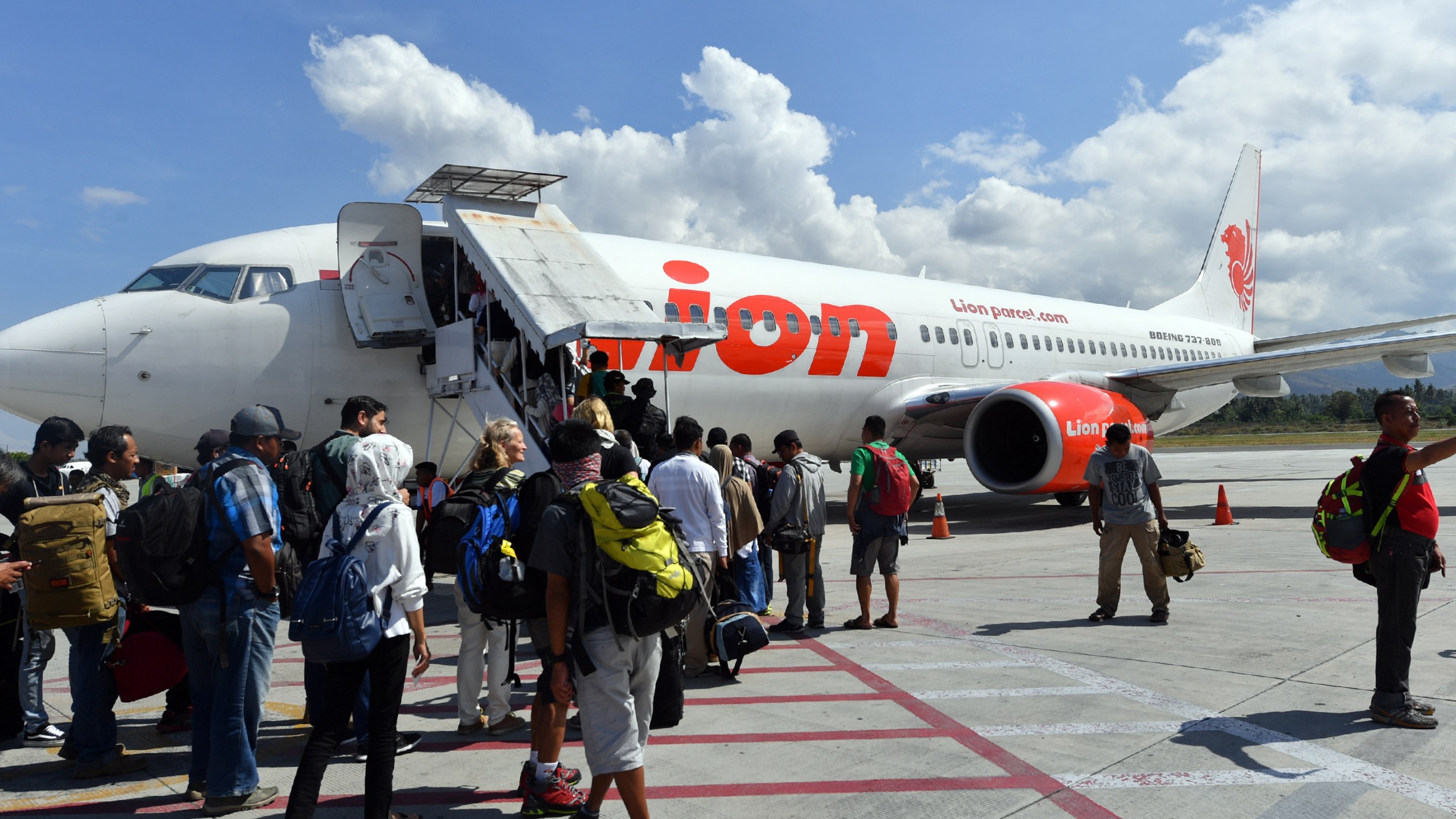 Passengers board a Lion Air Boeing 737-800 aircraft at the Mutiara Sis Al Jufri airport in Palu on Oct. 10, 2018, days after the airport reopened following the Sept. 28 earthquake and tsunami. (Credit: Adek Berry / AFP / Getty Images)
