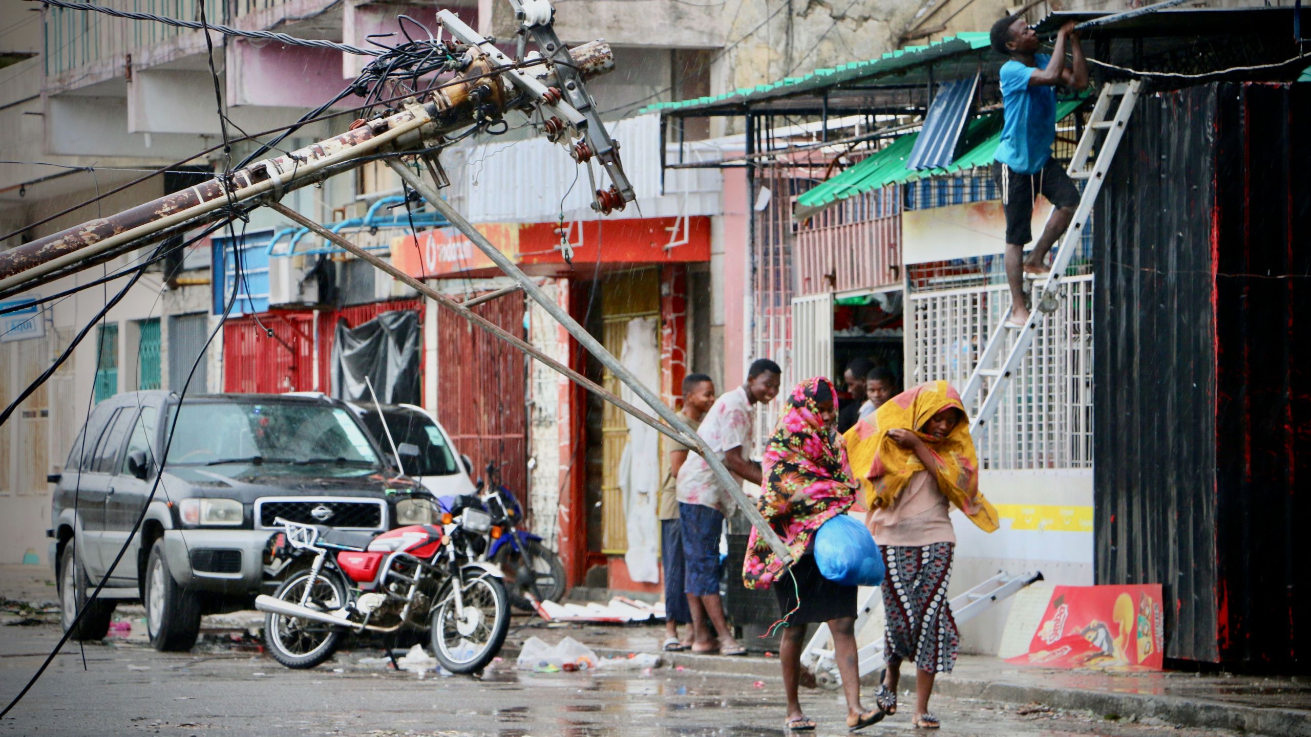Residents walk on the street on March 17, 2019. after cyclone Idai passed Beira, Mozambique. (Credit: ADRIEN BARBIER/AFP/Getty Images)