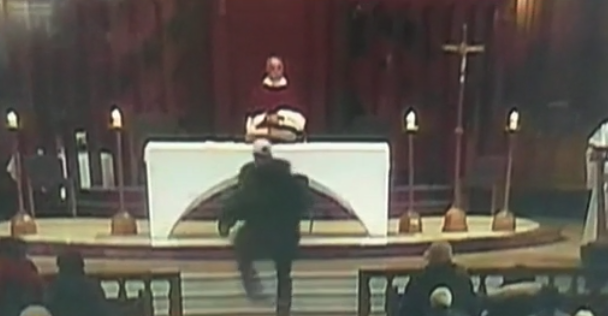 An attacker rushes the altar during a Mass in Montreal, Canada. (Credit: CNN)
