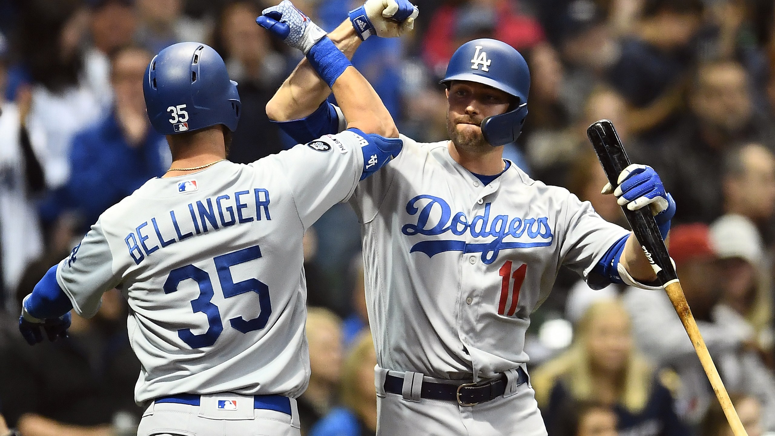 Cody Bellinger #35 of the Los Angeles Dodgers is congratulated by A.J. Pollock #11 following a solo home run against the Milwaukee Brewers during the sixth inning at Miller Park on April 18, 2019 in Milwaukee, Wisconsin. (Credit: Stacy Revere/Getty Images)