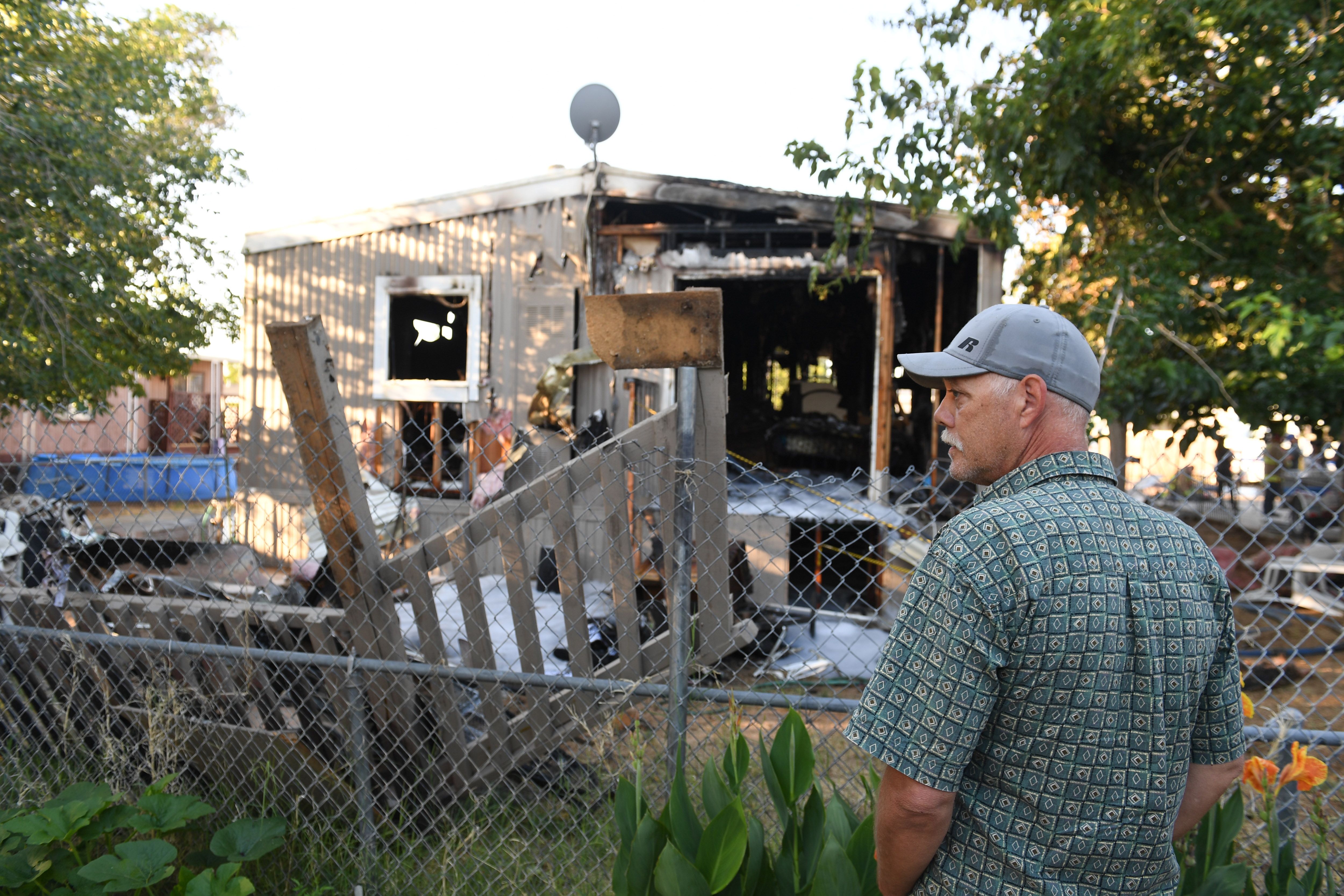 Terry Brantley looks at his neighbor's home after it burnt down in an electrical fire following a magnitude 7.1 earthquake in Ridgecrest on July 6, 2019.(Credit: ROBYN BECK/AFP/Getty Images)