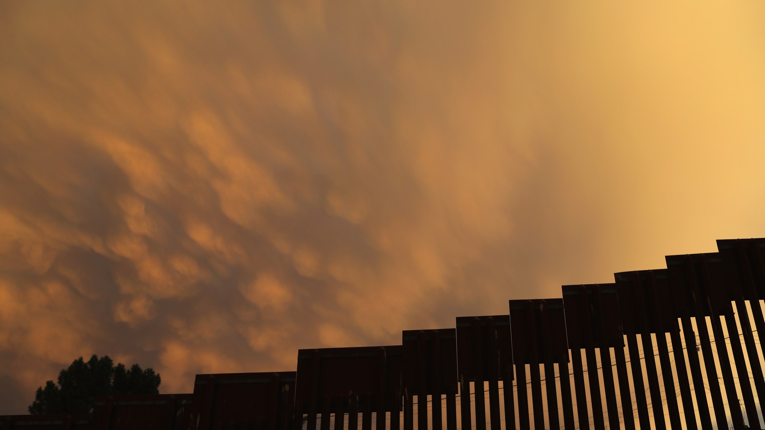 The U.S.-Mexico border fence is seen at sunset on July 22, 2018 in Nogales, Arizona. (Credit: John Moore/Getty Images)