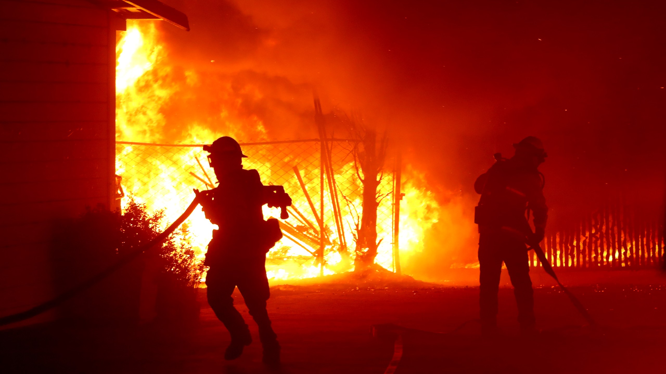 Firefighters battle the Kincade Fire as it burns a barn on Oct. 27, 2019, in Santa Rosa, Calif. (Credit: Justin Sullivan/Getty Images)