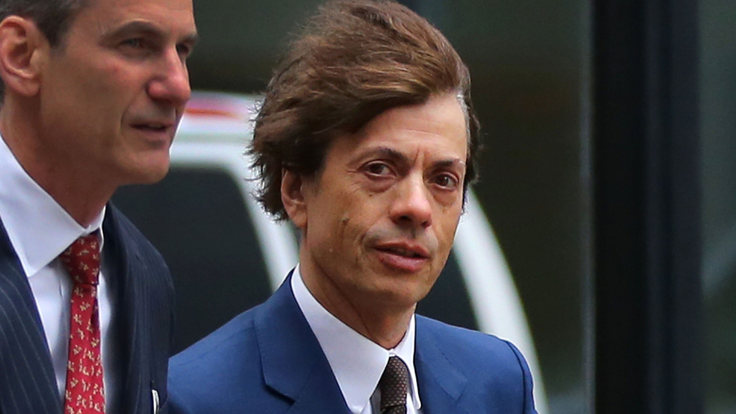 Napa Valley vintner Agustin Huneeus Jr., center, makes his way to the John Joseph Moakley U.S. Courthouse to plea in front of a judge on March 29, 2019, in Boston. (Credit: The Boston Globe/Getty Images via CNN)