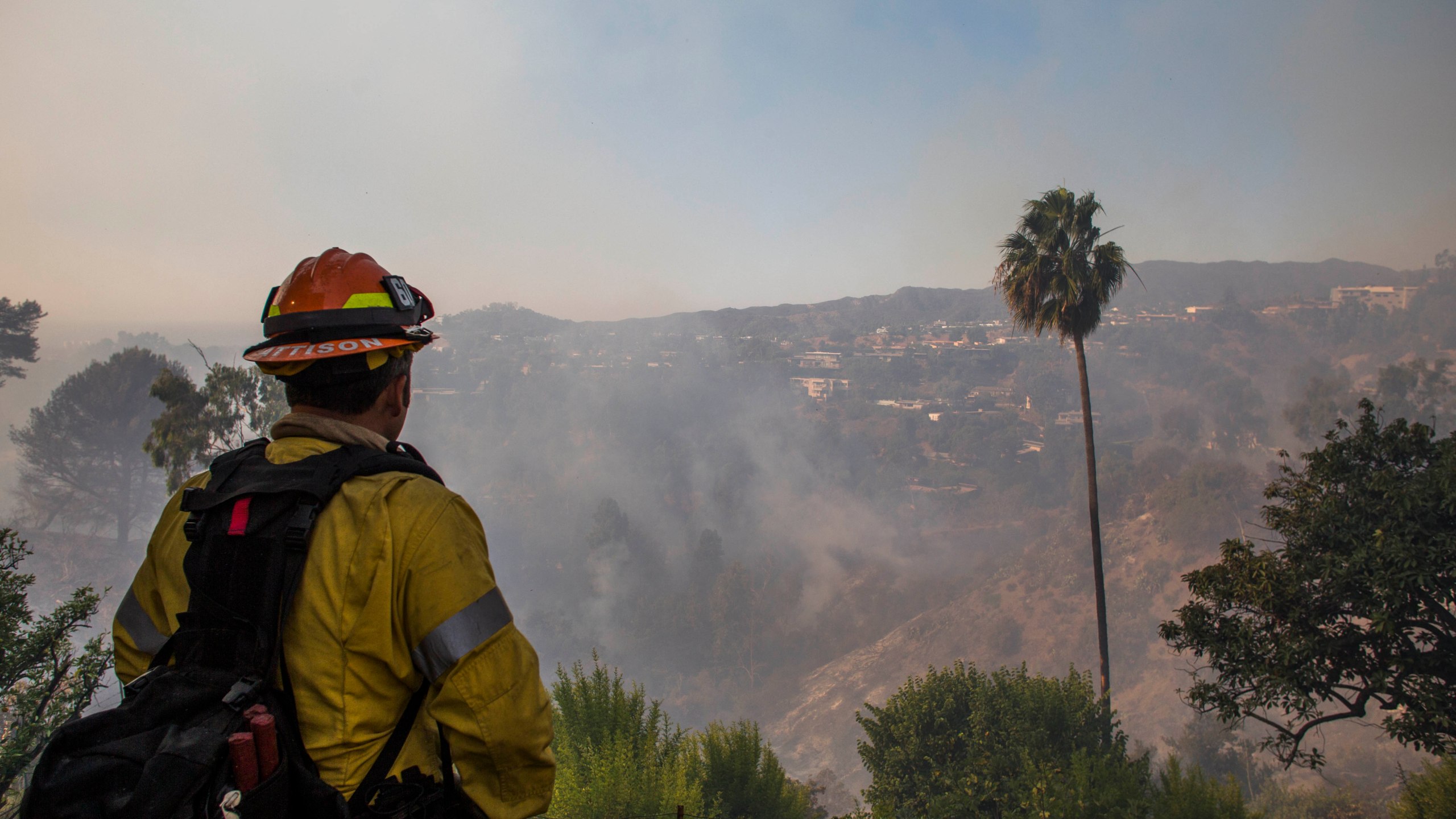 Firefighters battle the Getty Fire in houses on fire in Brentwood, California on Oct. 28, 2019. (Credit: APU GOMES/AFP via Getty Images)
