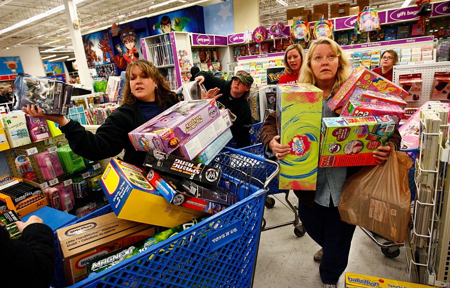 Shoppers Jeri Hull (L) and Karen Brashear (R) wait in line while shopping at Toys"R"Us during the Black Friday sales event on November 27, 2009 in Fort Worth, Texas. (Credit: Tom Pennington/Getty Images)