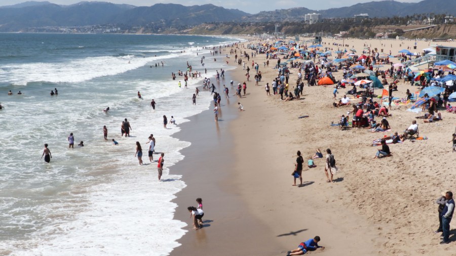 Tourists and Angelenos enjoy the beach in Santa Monica, California, on April 21, 2019. (DANIEL SLIM/AFP via Getty)