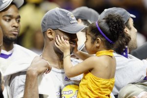 Kobe Bryant holds his daughter, Gianna, after the Lakers defeated the Orlando Magic in Game Five of the 2009 NBA Finals on June 14, 2009, at Amway Arena in Orlando, Florida. (Credit: Ronald Martinez/Getty Images)