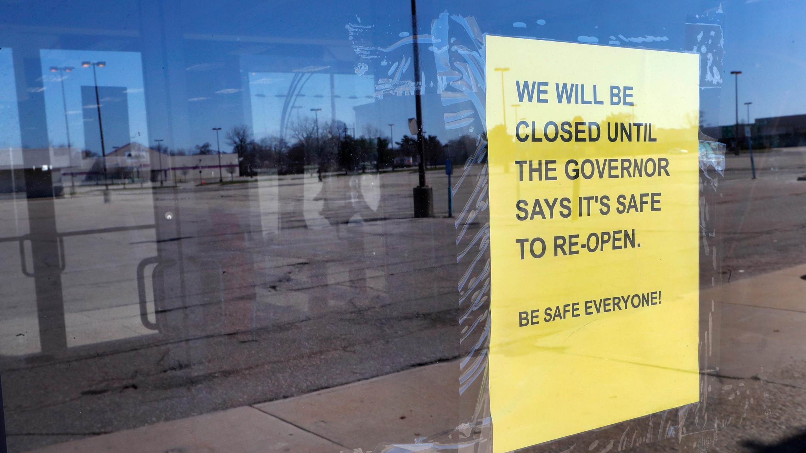 A closed sign is shown with an empty parking lot in Detroit, Thursday, April 2, 2020. (Paul Sancya/AP)