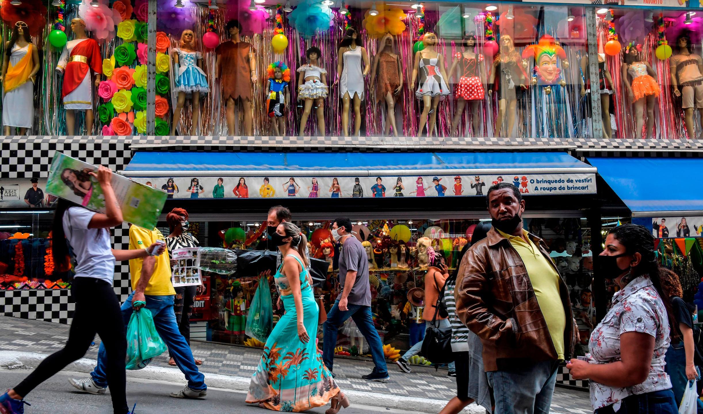 People walk along a street in downtown Sao Paulo, Brazil on June 10, 2020. (NELSON ALMEIDA/AFP/Getty Images)