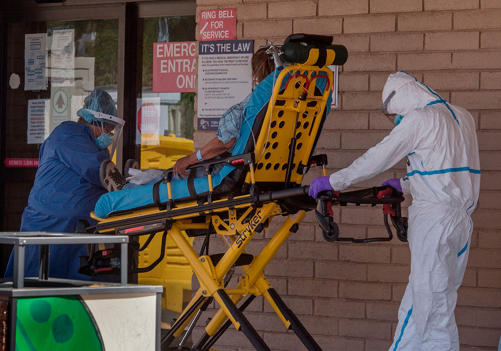 A patient is taken from an ambulance to the emergency room of a hospital in the Navajo Nation town of Tuba City during the 57 hour curfew, imposed to try to stop the spread of the COVID-19 virus through the Navajo Nation, in Arizona on May 24, 2020. (MARK RALSTON/AFP via Getty Images)