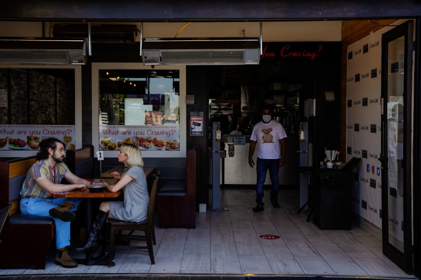 AJ Shalob, right, stands in his family-owned Studio City restaurant, Crave Cafe, in this undated photo. (Kent Nishimura / Los Angeles Times)