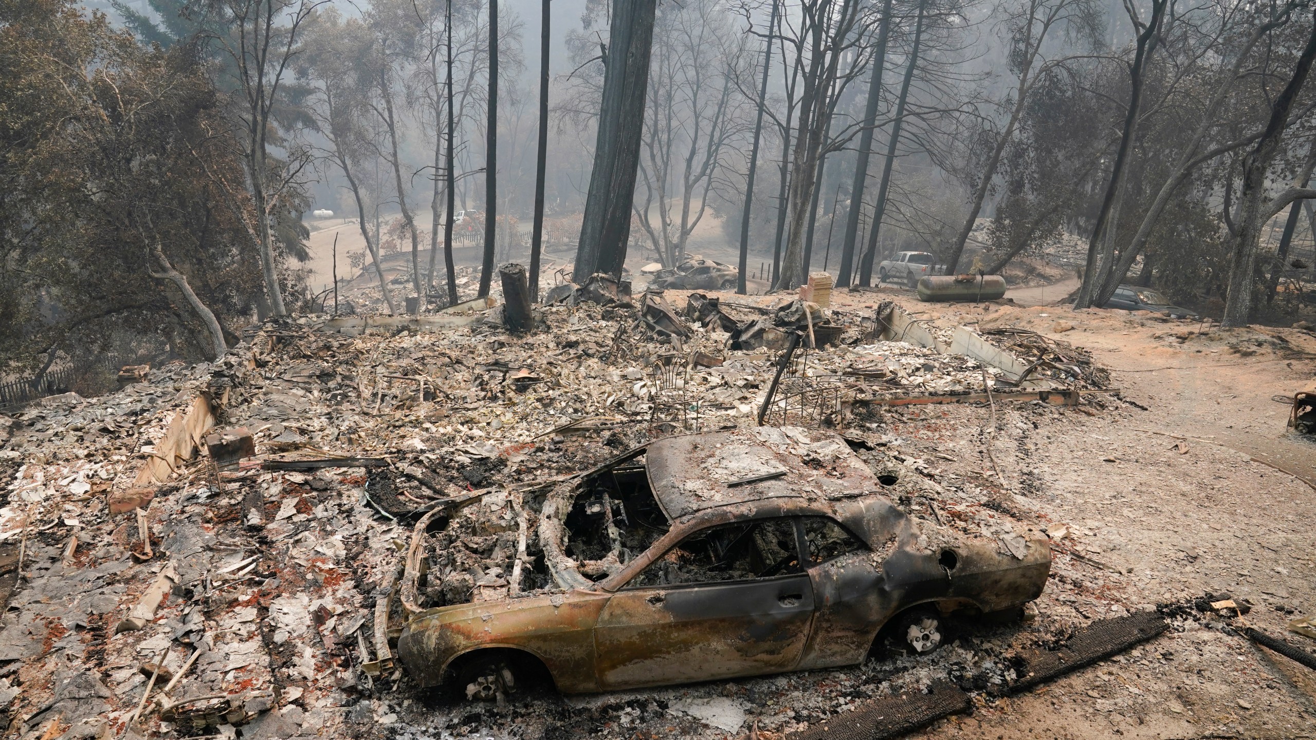 A fire-ravaged neighborhood is seen Tuesday, Aug. 25, 2020, in Boulder Creek, Calif., after the the CZU August Lightning Complex Fire passed by. (AP Photo/Marcio Jose Sanchez)