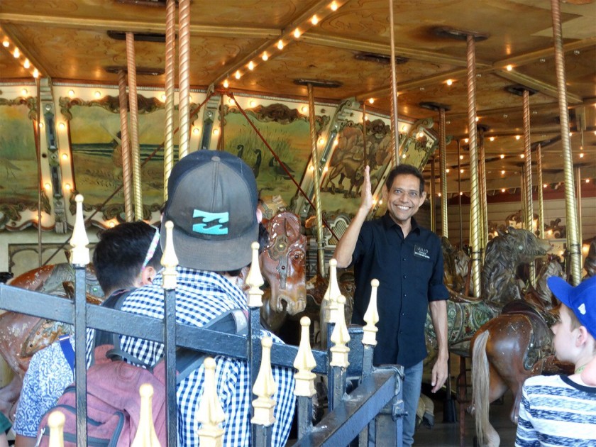 Julio Gosdinski welcomes riders to the Griffith Park carousel, where he worked for three decades, in this undated photo. (Kathryn Louyse via L.A. Times)