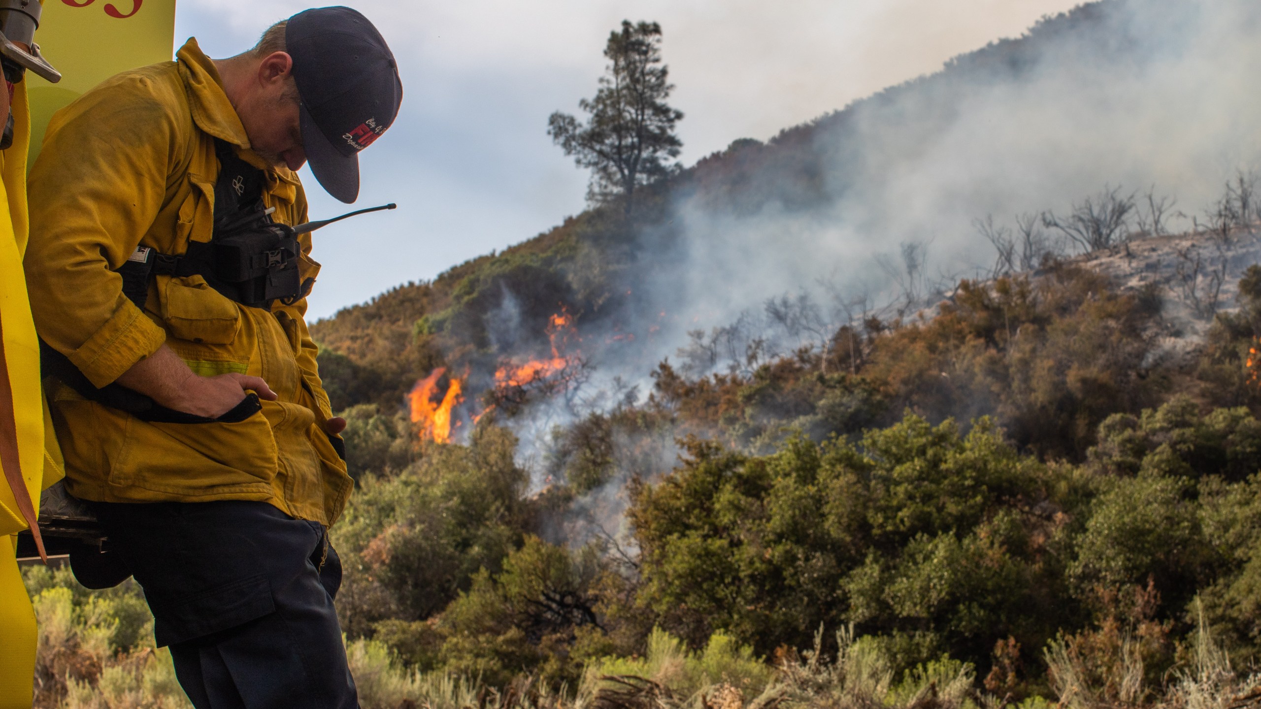 A Riverside firefighter takes a break from extinguishing hotspots from the Lake Fire at Pine Canyon Road in the Angeles National Forest, by Lake Hughes, 60 miles north of Los Angeles, California on Aug. 15, 2020. (APU GOMES/AFP via Getty Images)