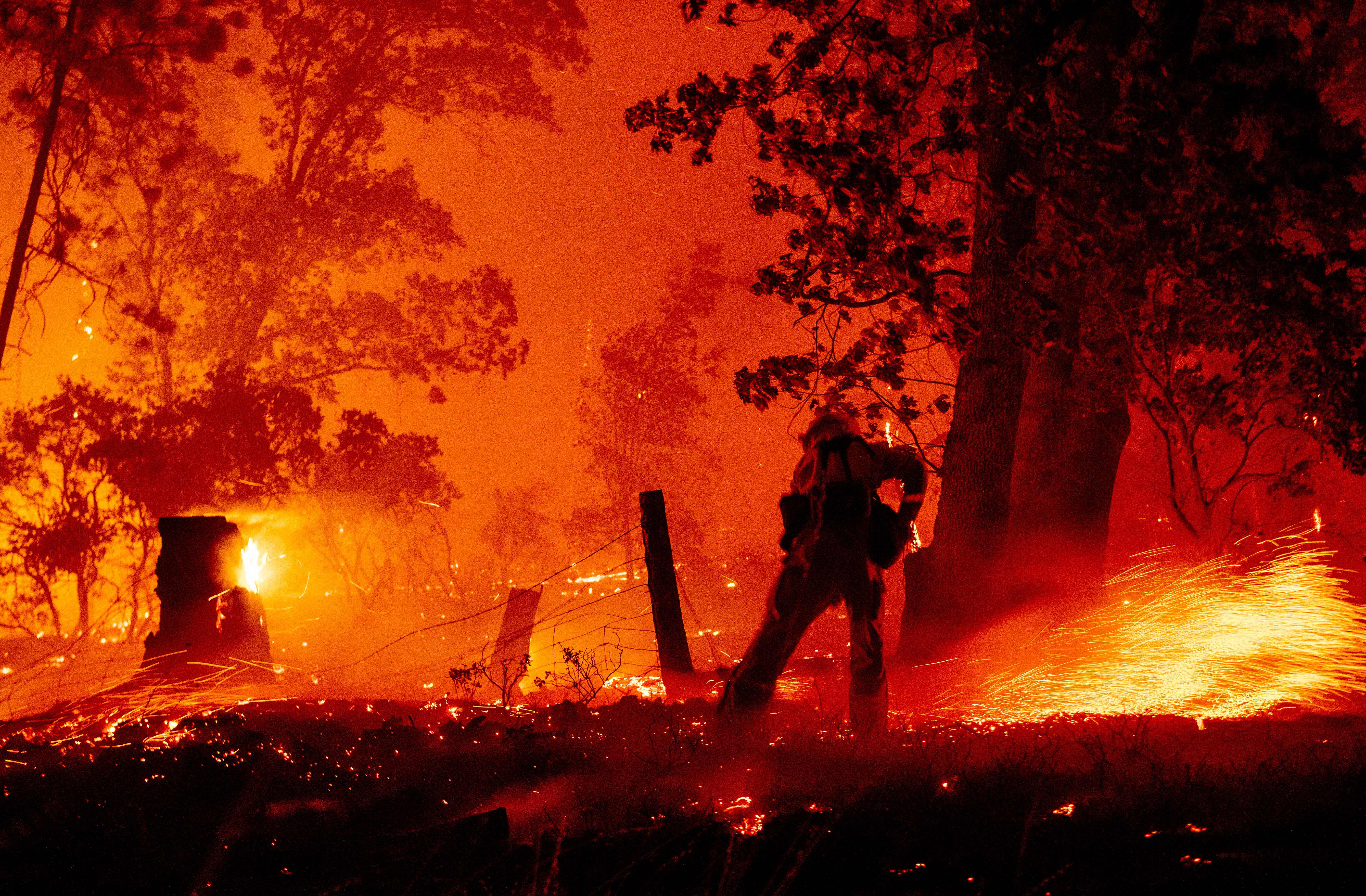 A firefighter works the line as flames push towards homes during the Creek fire in the Cascadel Woods area of unincorporated Madera County, California on September 7, 2020. (Photo by JOSH EDELSON/AFP via Getty Images)