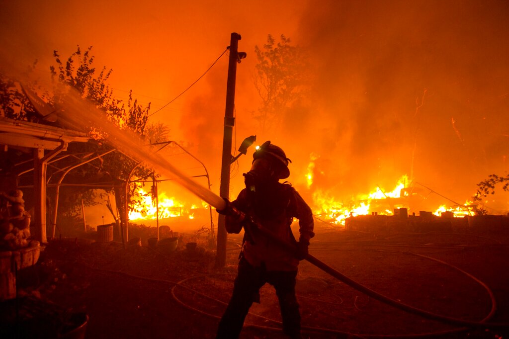 A firefighter works against the Lake Hughes Fire in Angeles National Forest north of Santa Clarita, Calif. (AP Photo/Ringo H.W. Chiu, File)
