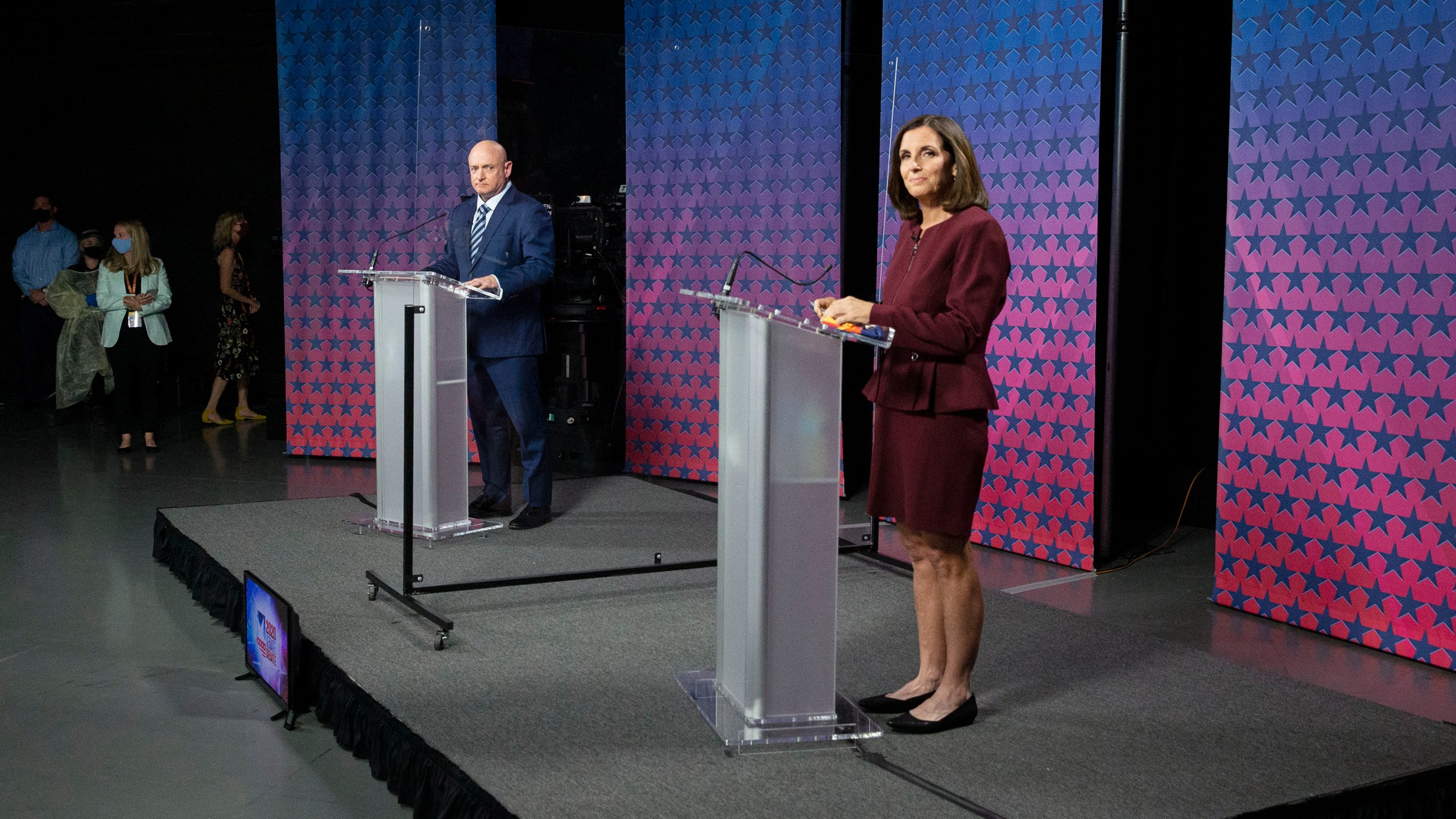 U.S. Senator Martha McSally (R-AZ) and Democratic challenger Mark Kelly are separated by plexiglass as they participate in a debate at the Walter Cronkite School of Journalism at Arizona State University in Phoenix, Arizona, on October 6, 2020. (Photo by Rob SCHUMACHER / POOL / AFP) (Photo by ROB SCHUMACHER/POOL/AFP via Getty Images)