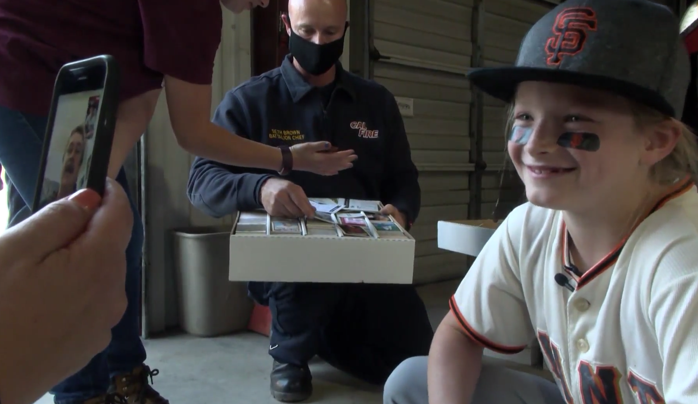 Reese Osterburg after Cal Fire surprised her with donated baseball cards. (KSEE)