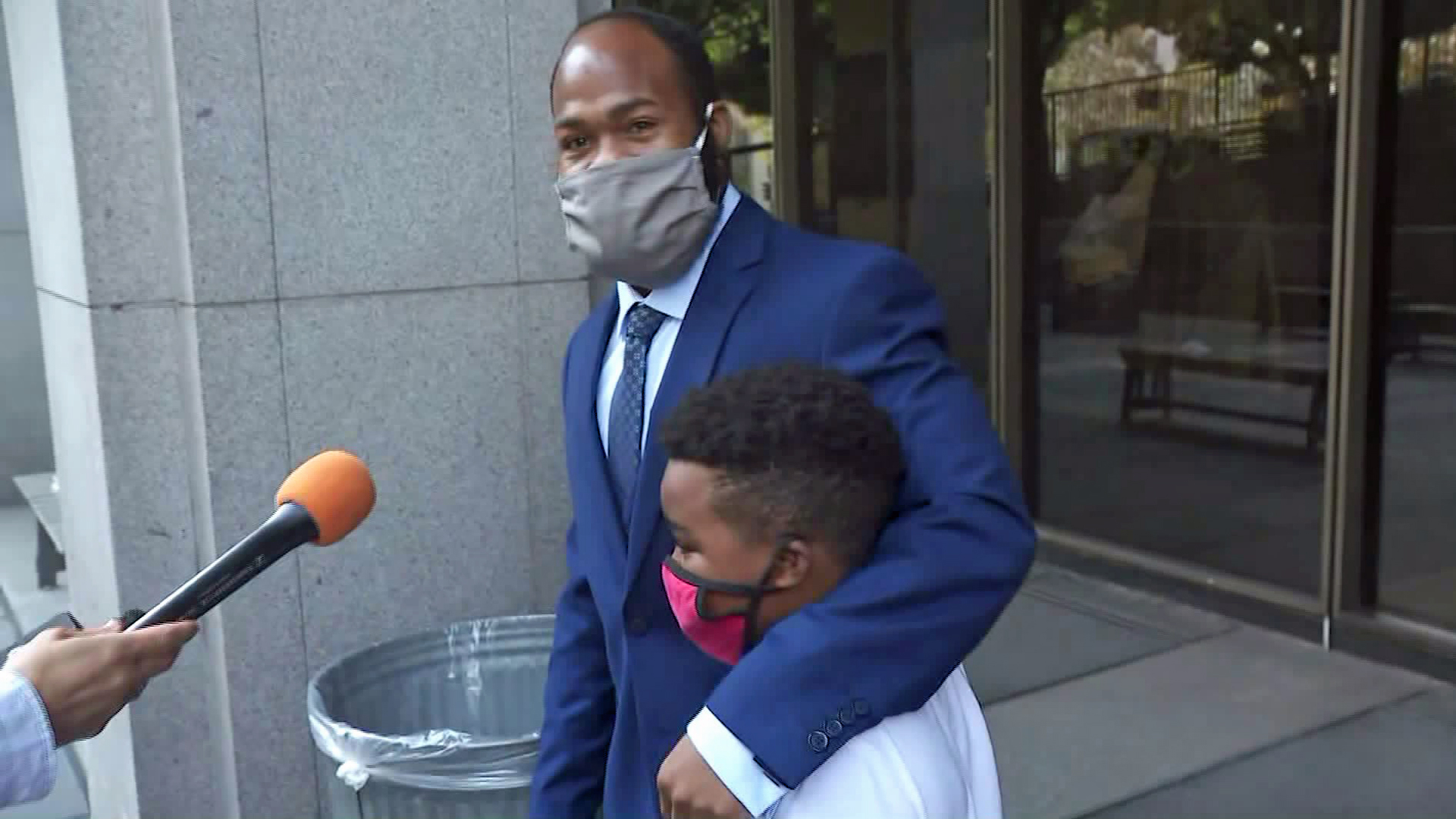 Derrick Harris walked out of a Los Angeles courtroom with his son on Oct. 6, 2020. (KTLA)