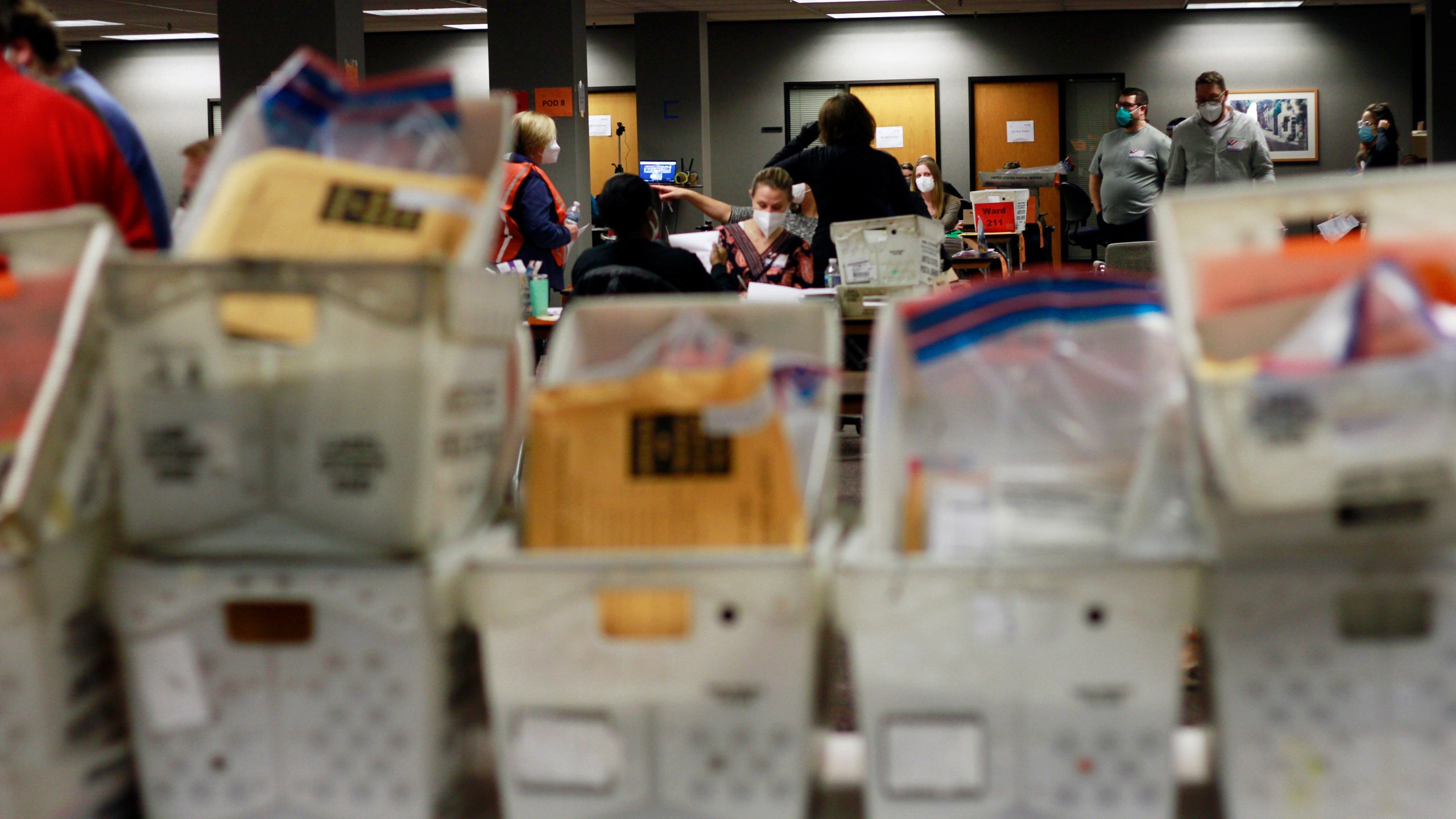 Election workers count absentee ballots into the early morning, Wednesday, Nov. 4, 2020 in Milwaukee at a central counting facility. (AP Photo/Stephen Groves)