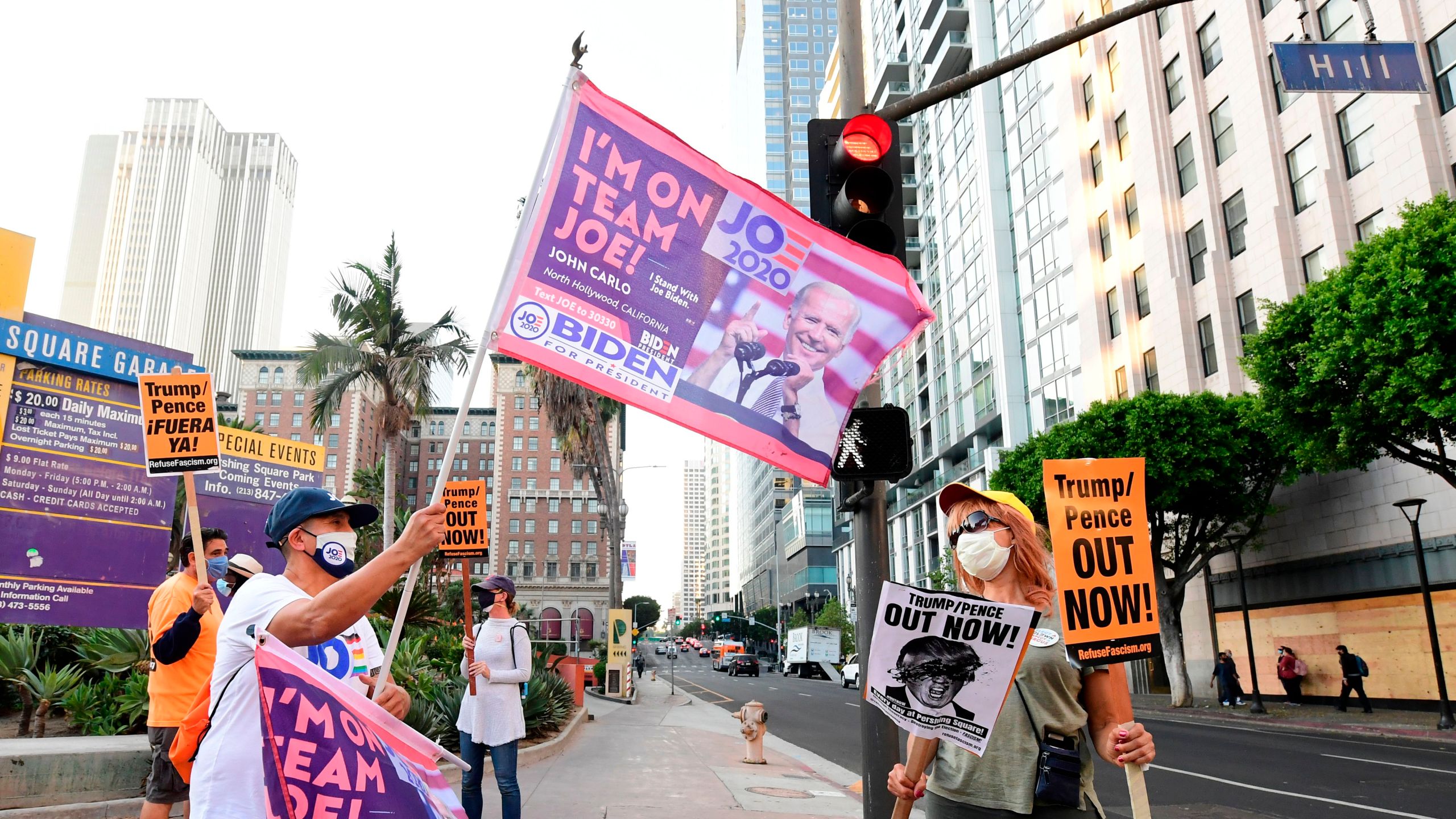 John Mena holds a flag showing support for Joe Biden as activists gather for a rally in downtown Los Angeles, California on November 4, 2020 a day after the presidential election. (Frederic J. Brown/AFP via Getty Images)