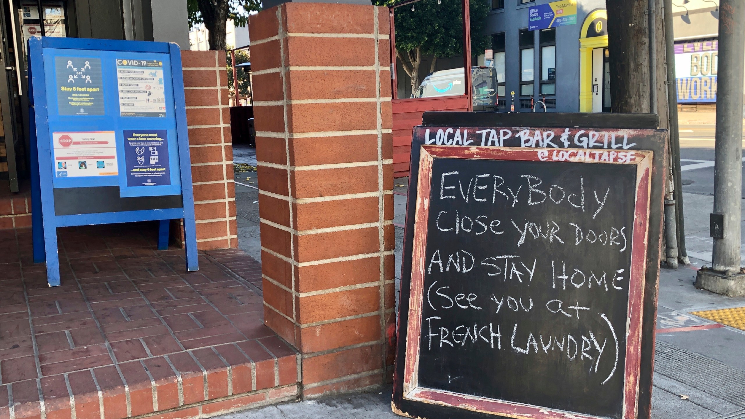 A sign calling out California Gov. Gavin Newsom for not following his own pandemic protocols at the French Laundry restaurant is seen in San Francisco on Dec. 8, 2020. (AP Photo/Juliet Williams)