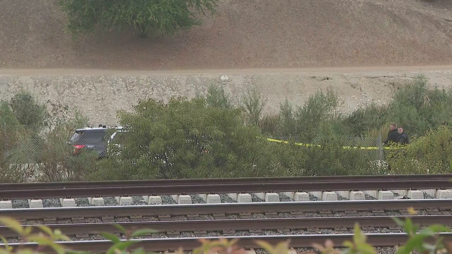 Officials respond to a body found in a riverbed in City of Industry on Dec. 11, 2020. (KTLA)