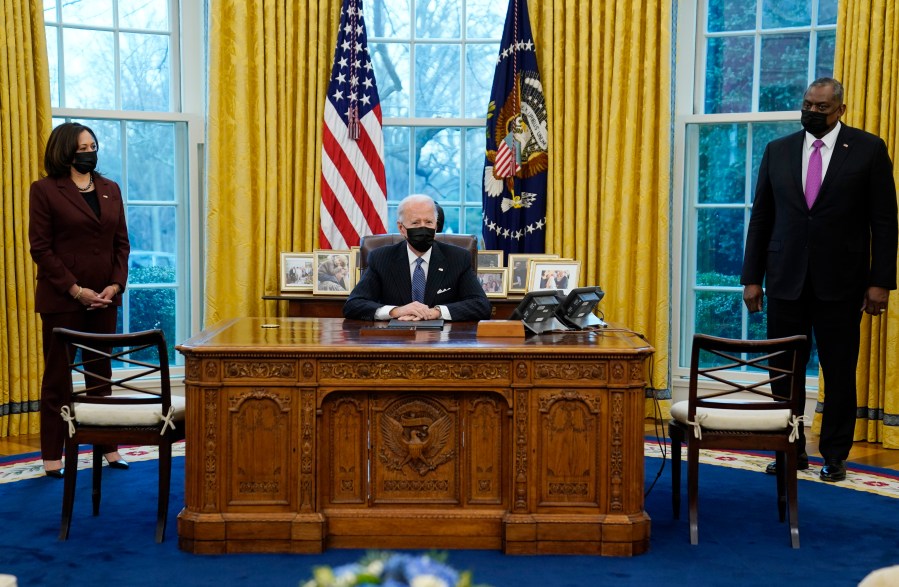 President Joe Biden meets with Secretary of Defense Lloyd Austin, Vice President Kamala Harris, in the Oval Office of the White House, Monday, Jan. 25, 2021, in Washington. (AP Photo/Evan Vucci)