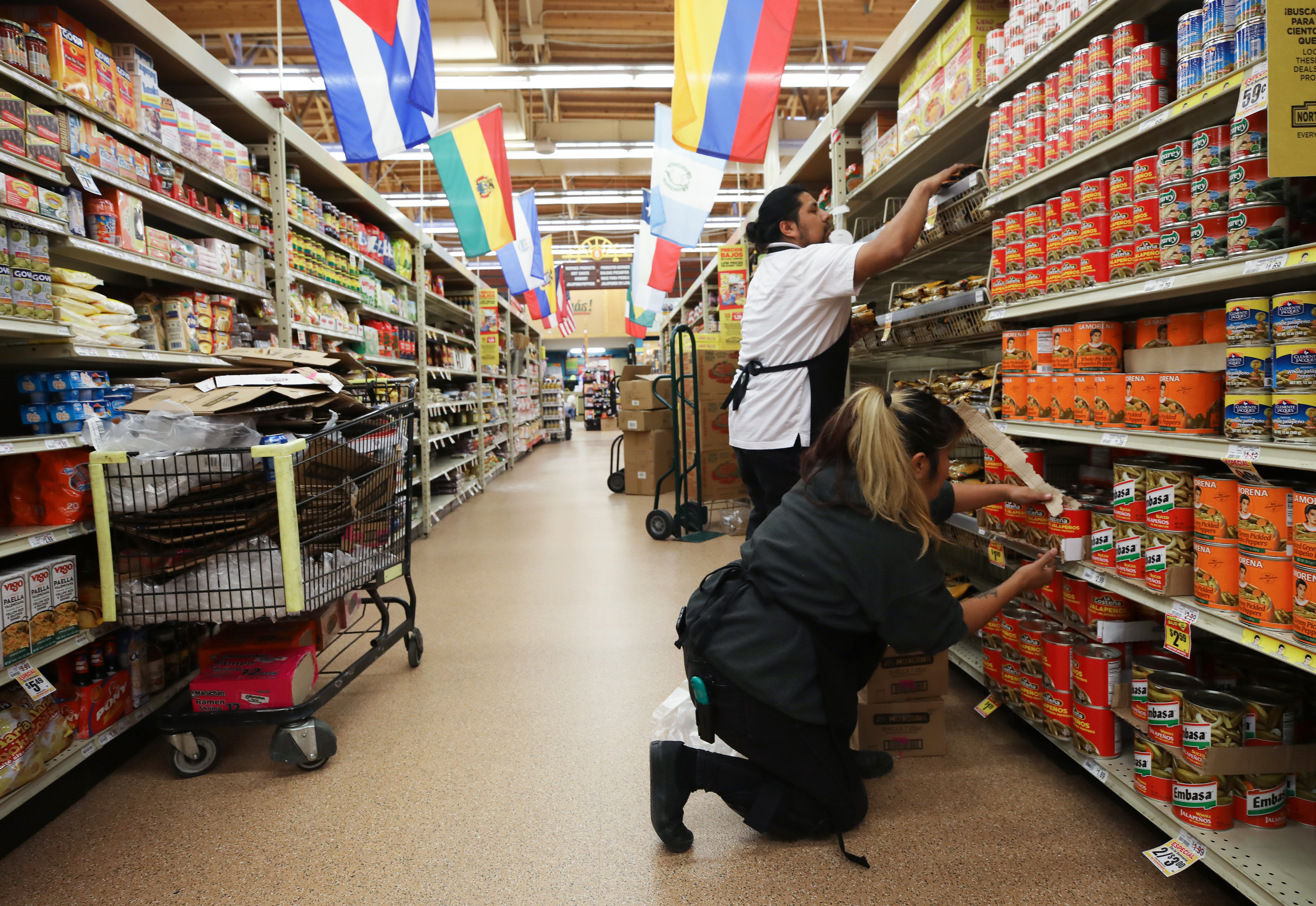 Workers re-stock items during special hours open only to seniors and the disabled at Northgate Gonzalez Market, a Hispanic specialty supermarket, on March 19, 2020 in Los Angeles, California. (Mario Tama/Getty Images)