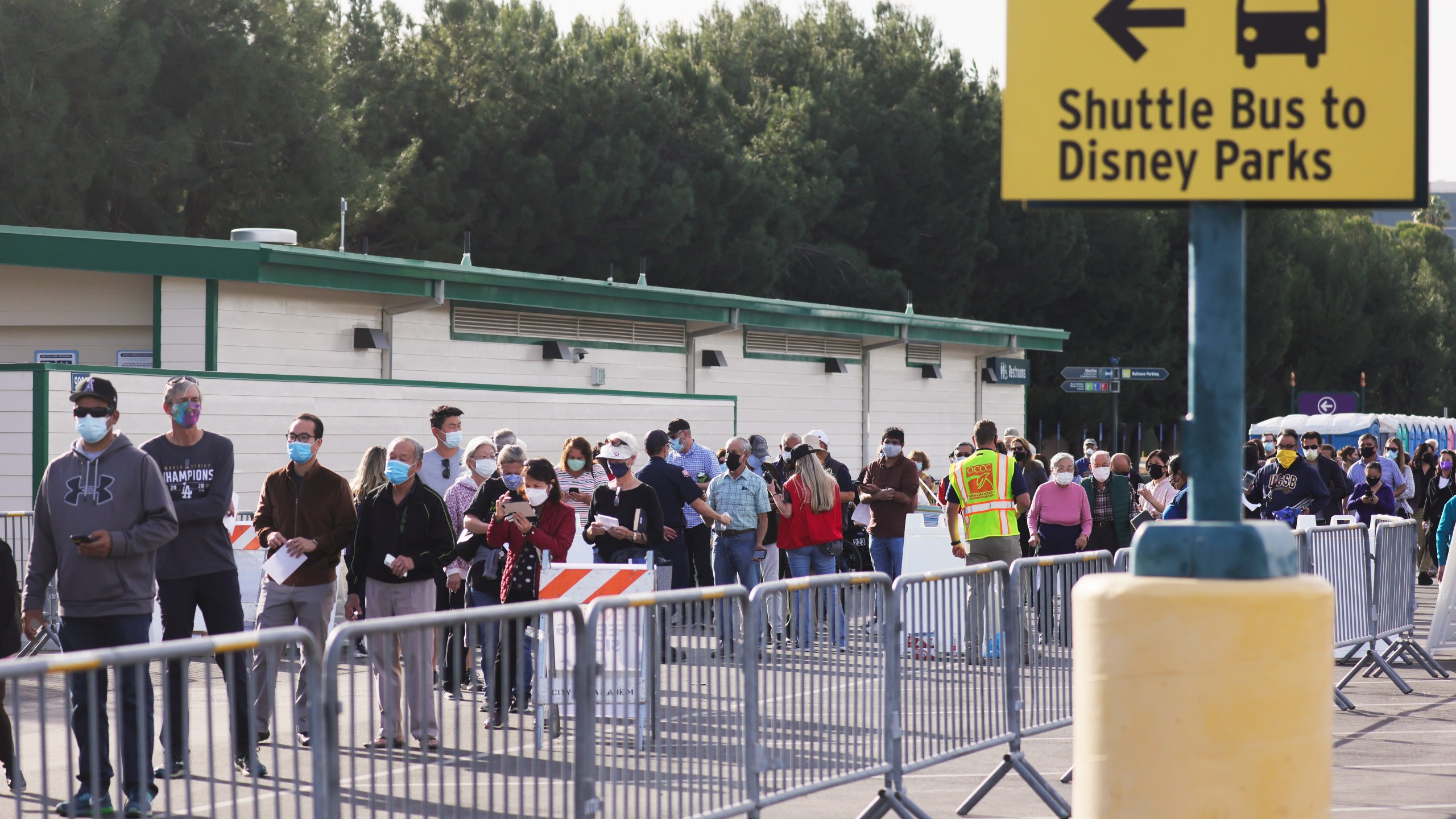 People wait in line to receive the COVID-19 vaccine at a mass vaccination site in a parking lot for Disneyland Resort on Jan. 13, 2021 in Anaheim. (Mario Tama/Getty Images)