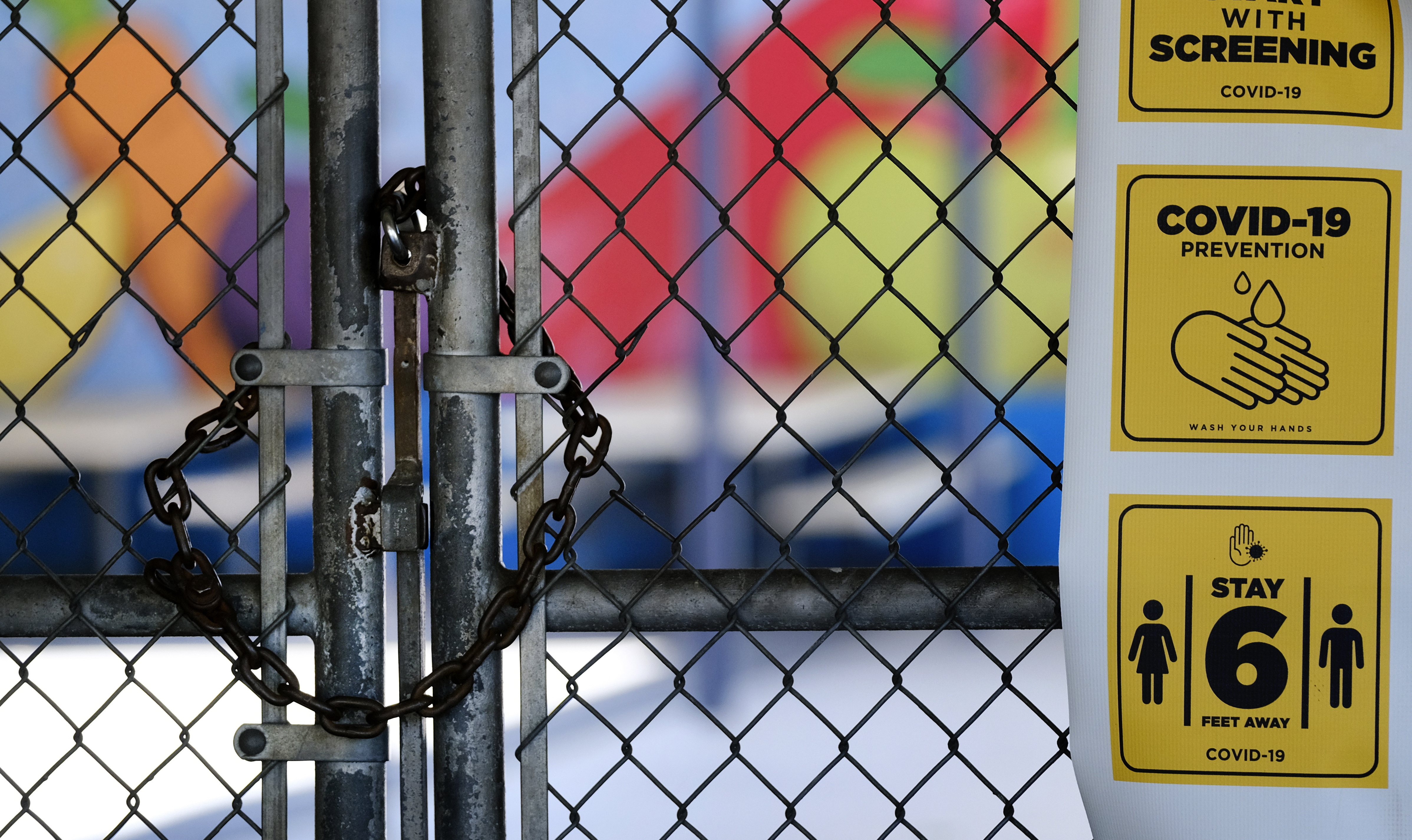 A gate is locked at the closed Ranchito Elementary School in Panorama City on July 13, 2020. (Richard Vogel / Associated Press)