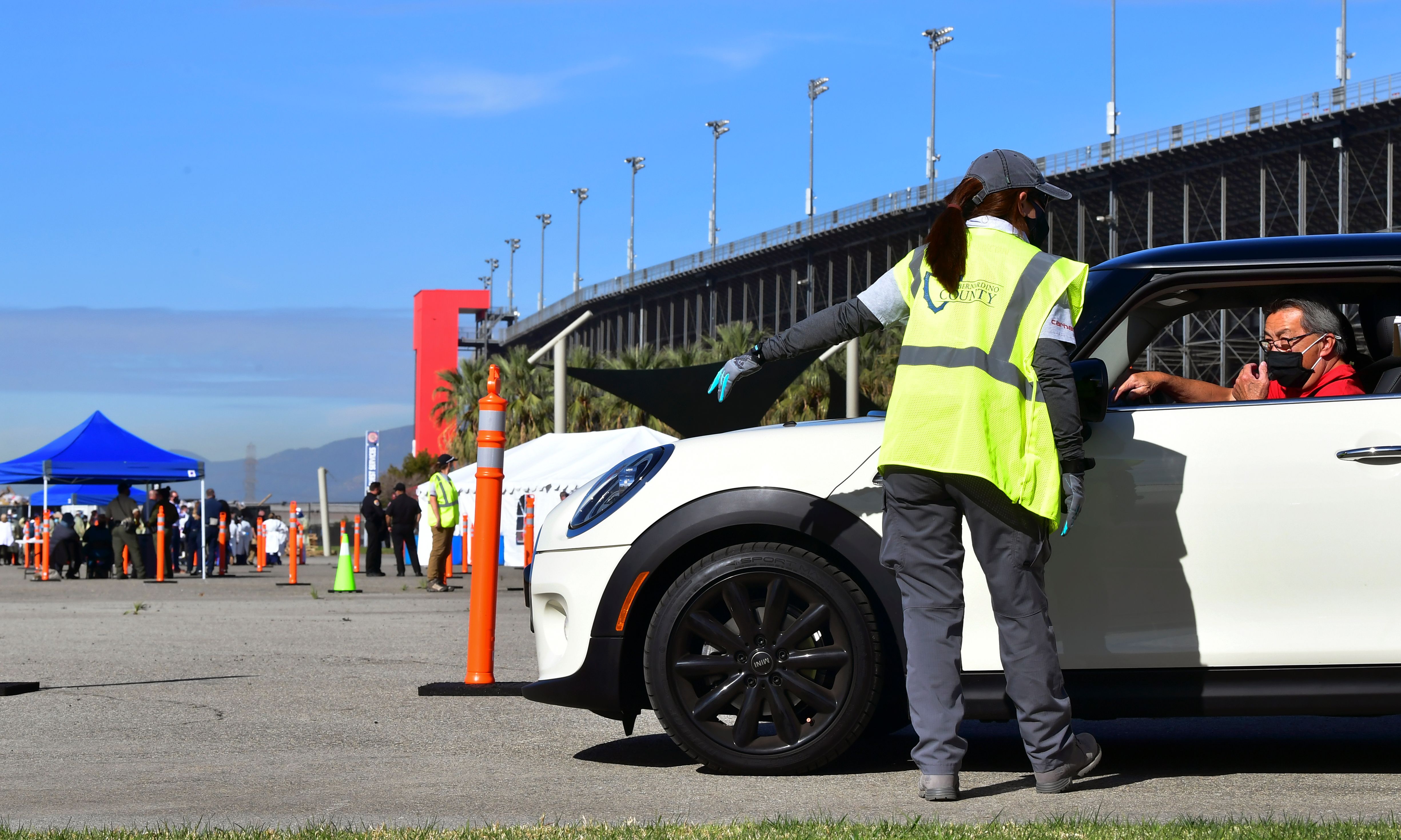 People arrive for their COVID-19 vaccine at the Auto Club Speedway in Fontana on Feb. 2, 2021. (Frederic J. Brown / AFP / Getty Images)