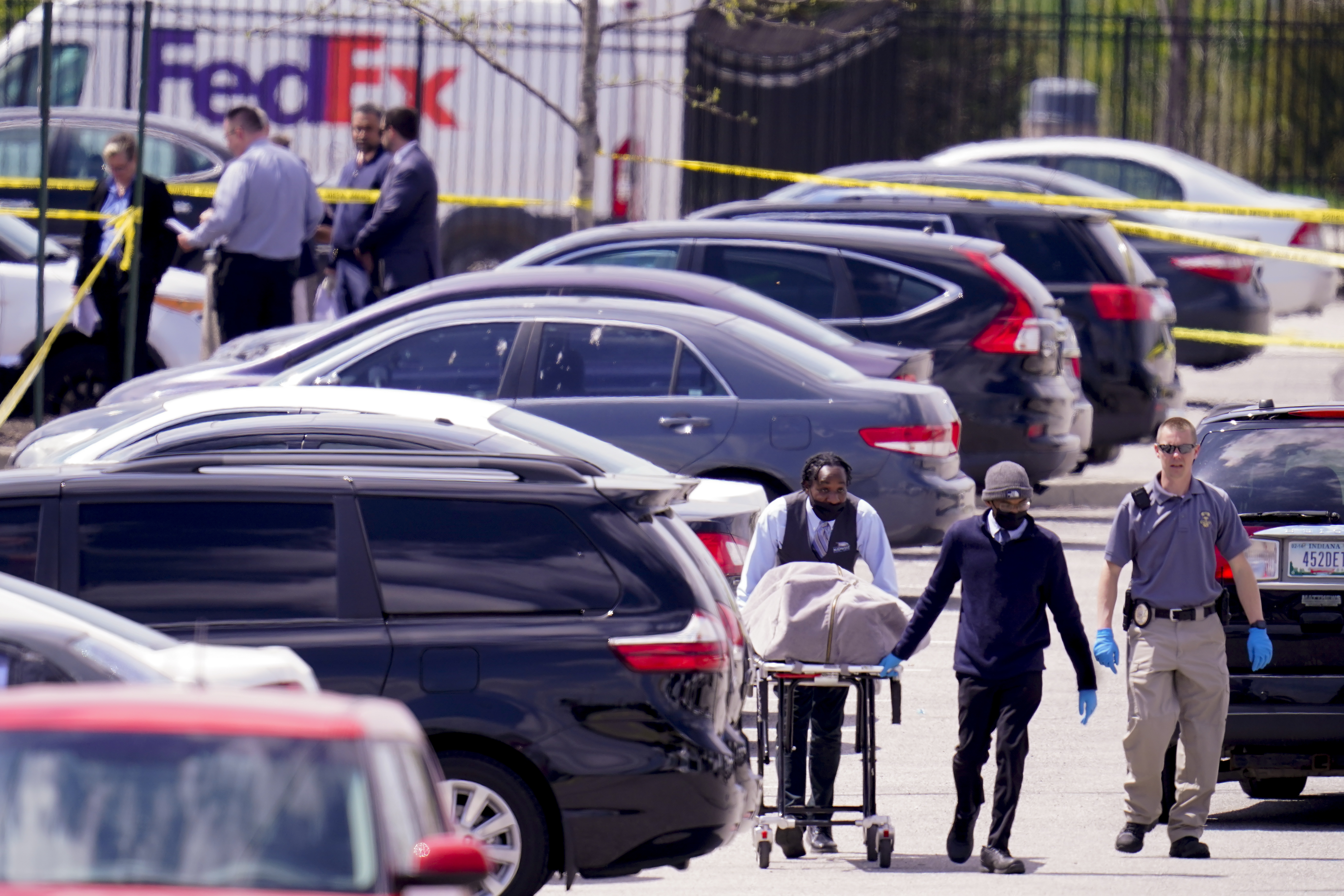 A body is taken from the scene where multiple people were shot at a FedEx Ground facility in Indianapolis, Friday, April 16, 2021. (AP Photo/Michael Conroy)