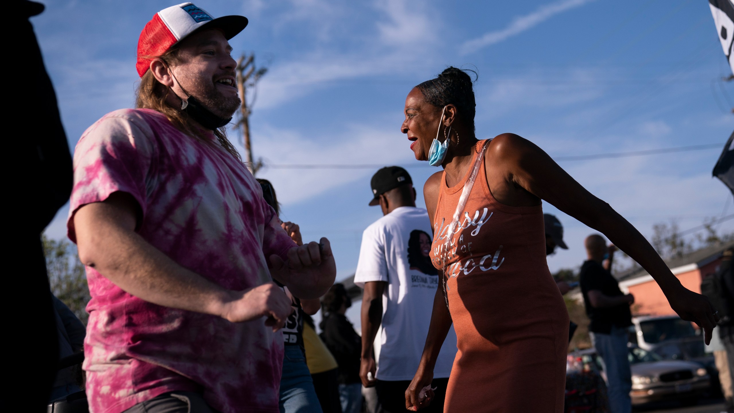 Sherri Burks, right, and Dominic Fawcett dance at the intersection of Florence and Normandie Avenues, on April 20, 2021, in Los Angeles, after a guilty verdict was announced at the trial of former Minneapolis police Officer Derek Chauvin for the 2020 death of George Floyd. (AP Photo/Jae C. Hong)