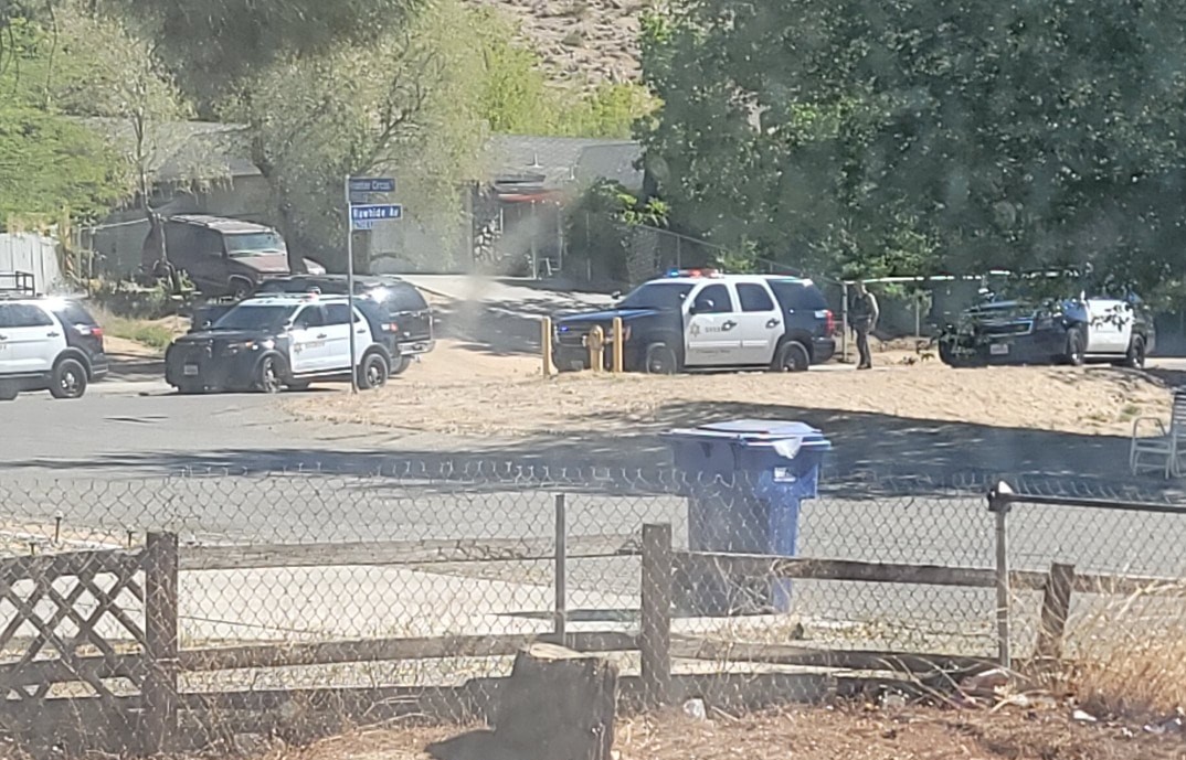 Los Angeles County Sheriff's Department patrol vehicles are parked outside a Lake Los Angeles home where deputies were responding to reports of a man brandishing a shotgun on April 29, 2021. (Beth Sotelo)