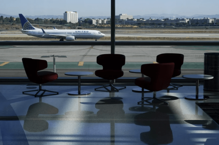An airplane taxis past a gate at the new West Gates at Tom Bradley International Terminal at Los Angeles International Airport on May 24, 2021.(Ashley Landis / Associated Press)