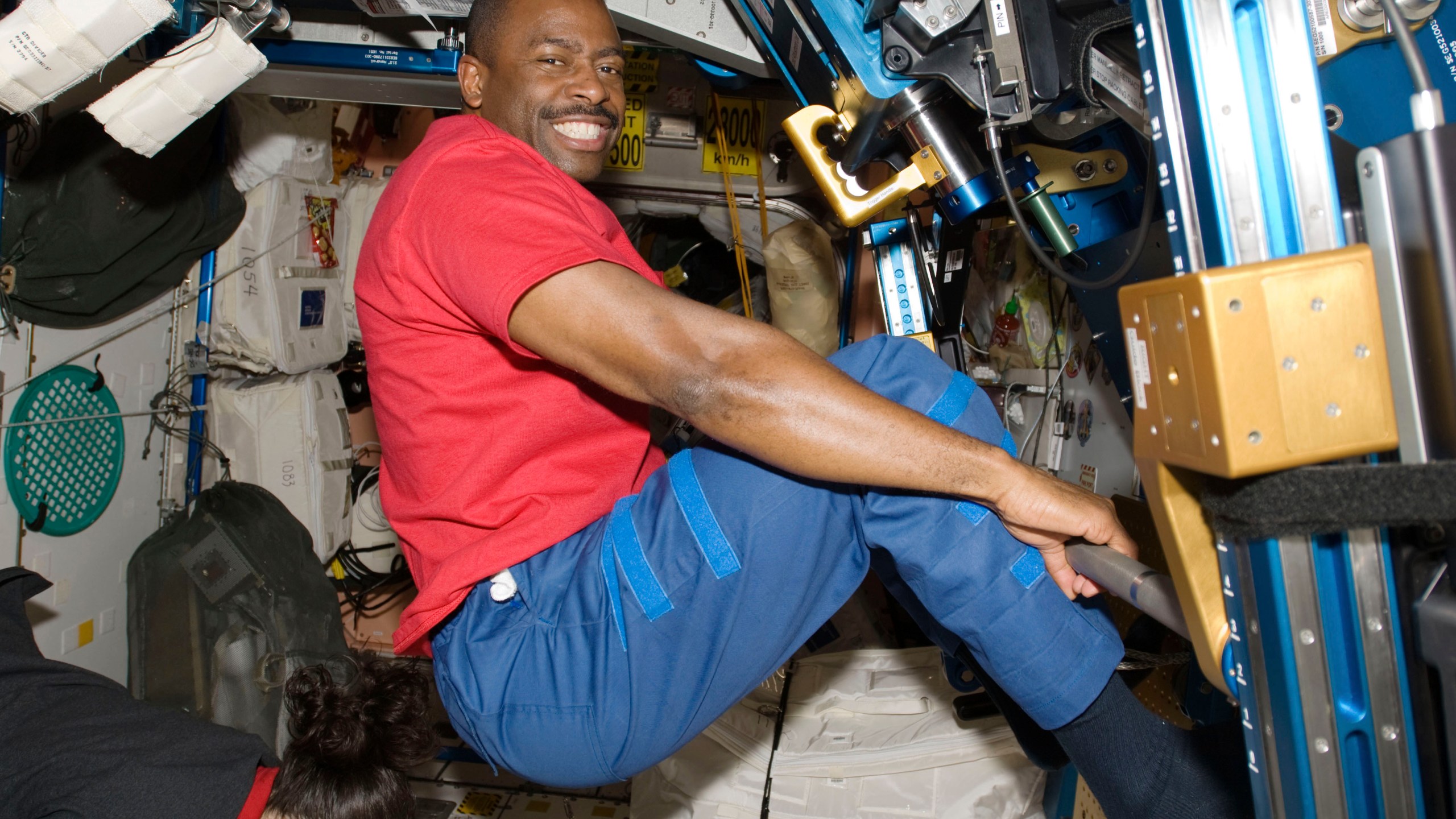 In this Nov. 22, 2009 photo made available by NASA, astronaut Leland Melvin, STS-129 mission specialist, exercises in the Unity module of the International Space Station while the space shuttle Atlantis is docked with the station. Space station astronauts exercise two hours every day to counter the muscle- and bone-withering effects of weightlessness, quickly leaving their workout clothes sweaty, smelly and stiff. Their T-shirts, shorts and socks end up so foul that they run through a pair every week, according to Melvin, a former NASA astronaut and NFL player. (NASA via AP)