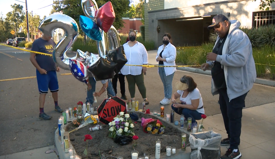 A memorial is erected at the site where a Long Beach housing complex's security guard was fatally struck in a hit-and-run on June 12, 2021. (KTLA)