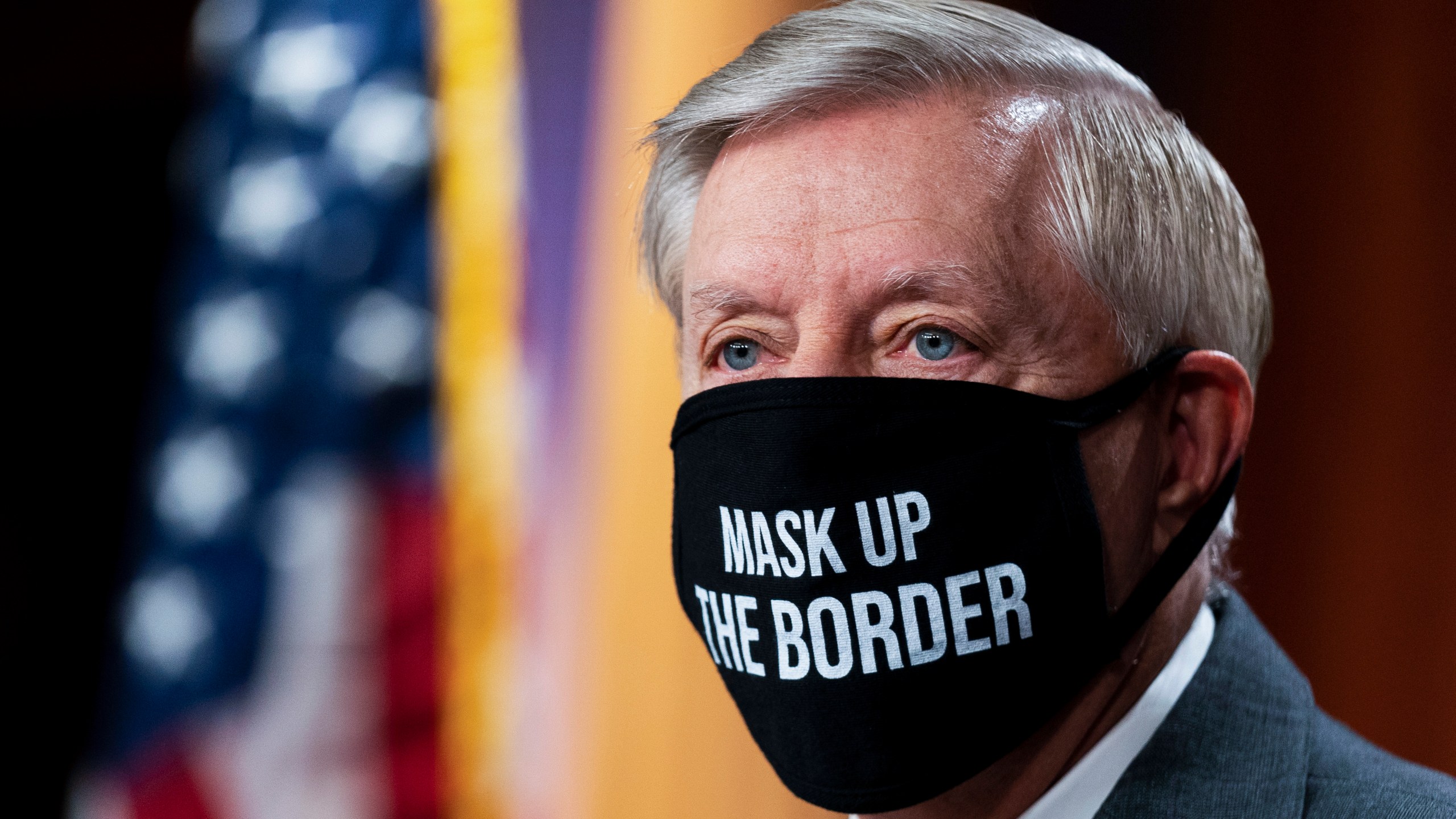 Sen. Lindsey Graham, R-S.C., wearing a mask, takes a pause at the start of a news conference about the United States/Mexico border at the Capitol in Washington, Friday, July 30, 2021. (AP Photo/Manuel Balce Ceneta)