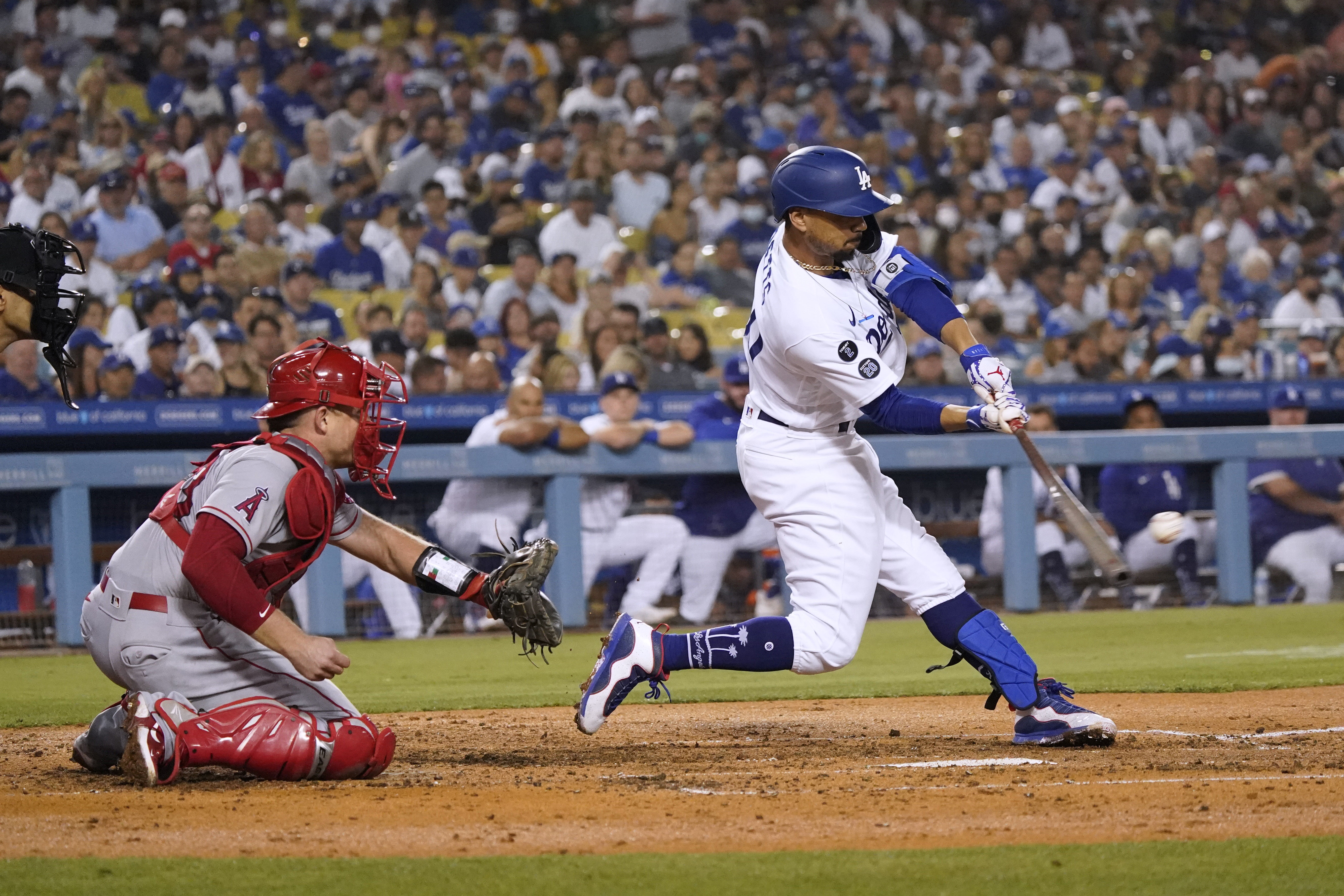 Los Angeles Dodgers' Mookie Betts drives in a run with a single during the fourth inning of the team's baseball game against the Los Angeles Angels on Aug. 6, 2021, in Los Angeles. Betts was taken out of the game with a sore him and was later placed on the injured list. (Marcio Jose Sanchez/Associated Press)